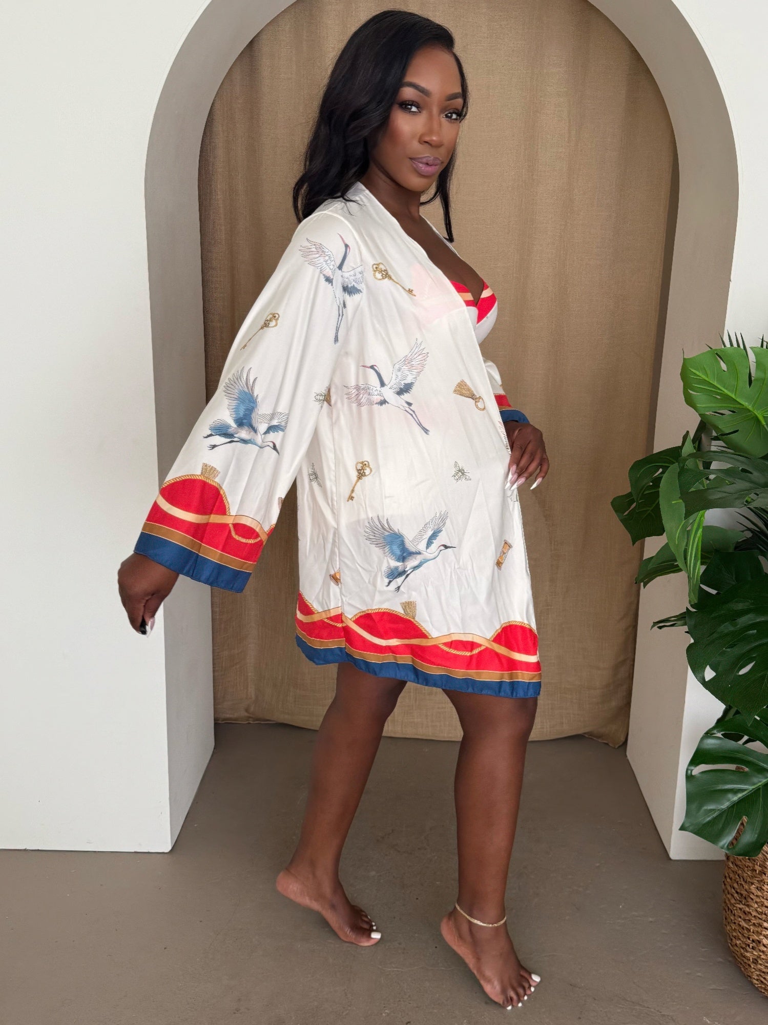 Crane key kimono robe in white with bird motif, oversized sleeves, red/blue hem trim