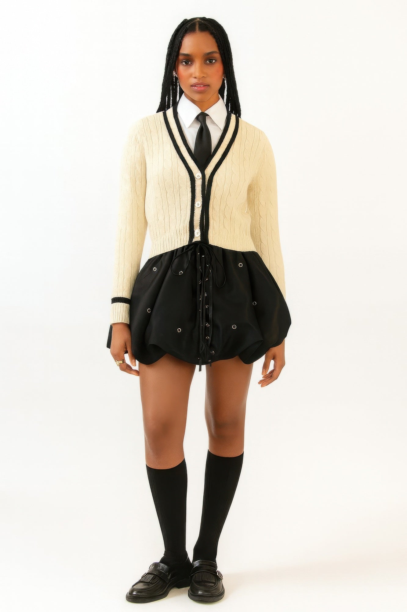 Black bubble mini skirt with eyelets and lace-up front, gathered at the waistband