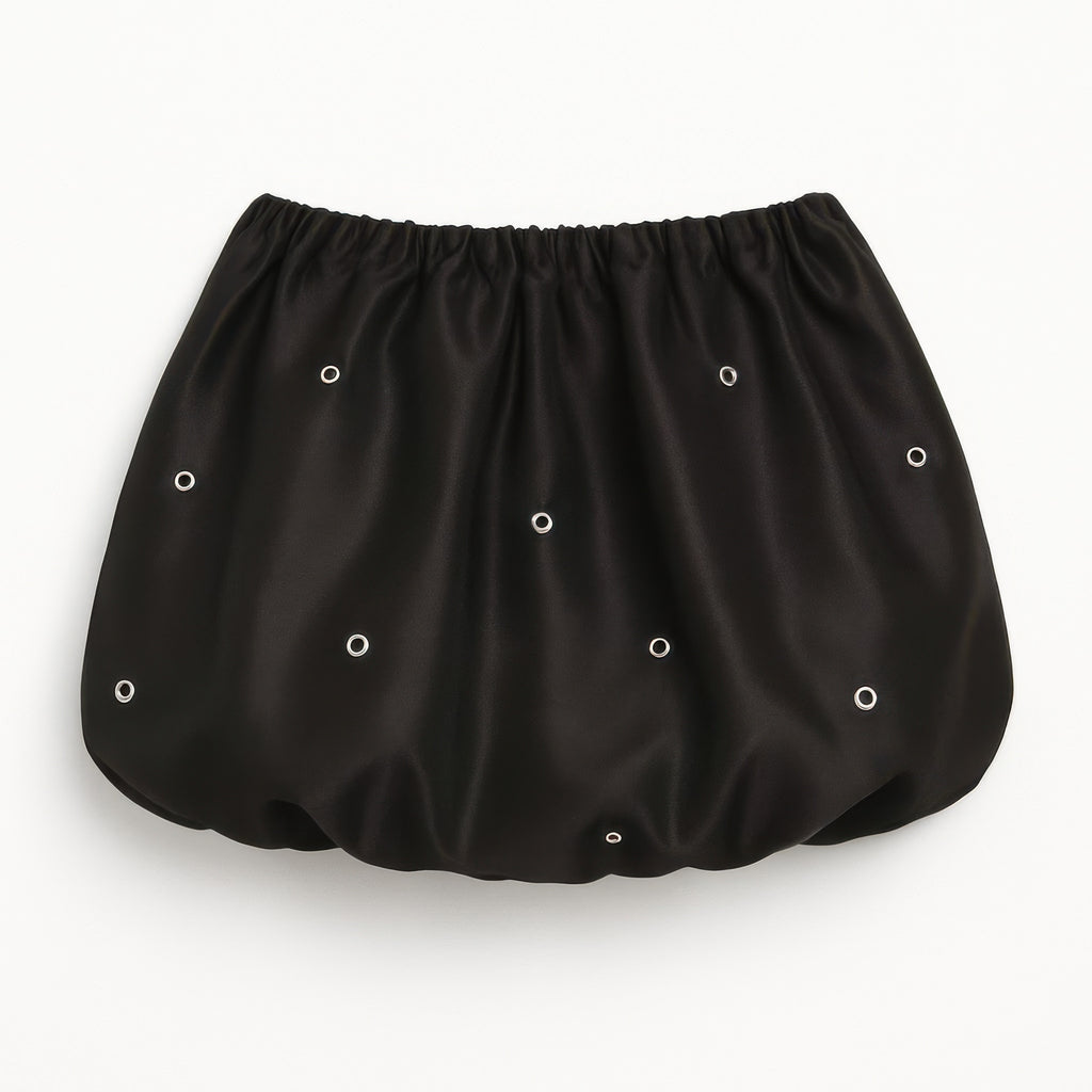 Black bubble mini skirt close-up: gathered waistband with silver eyelet pattern