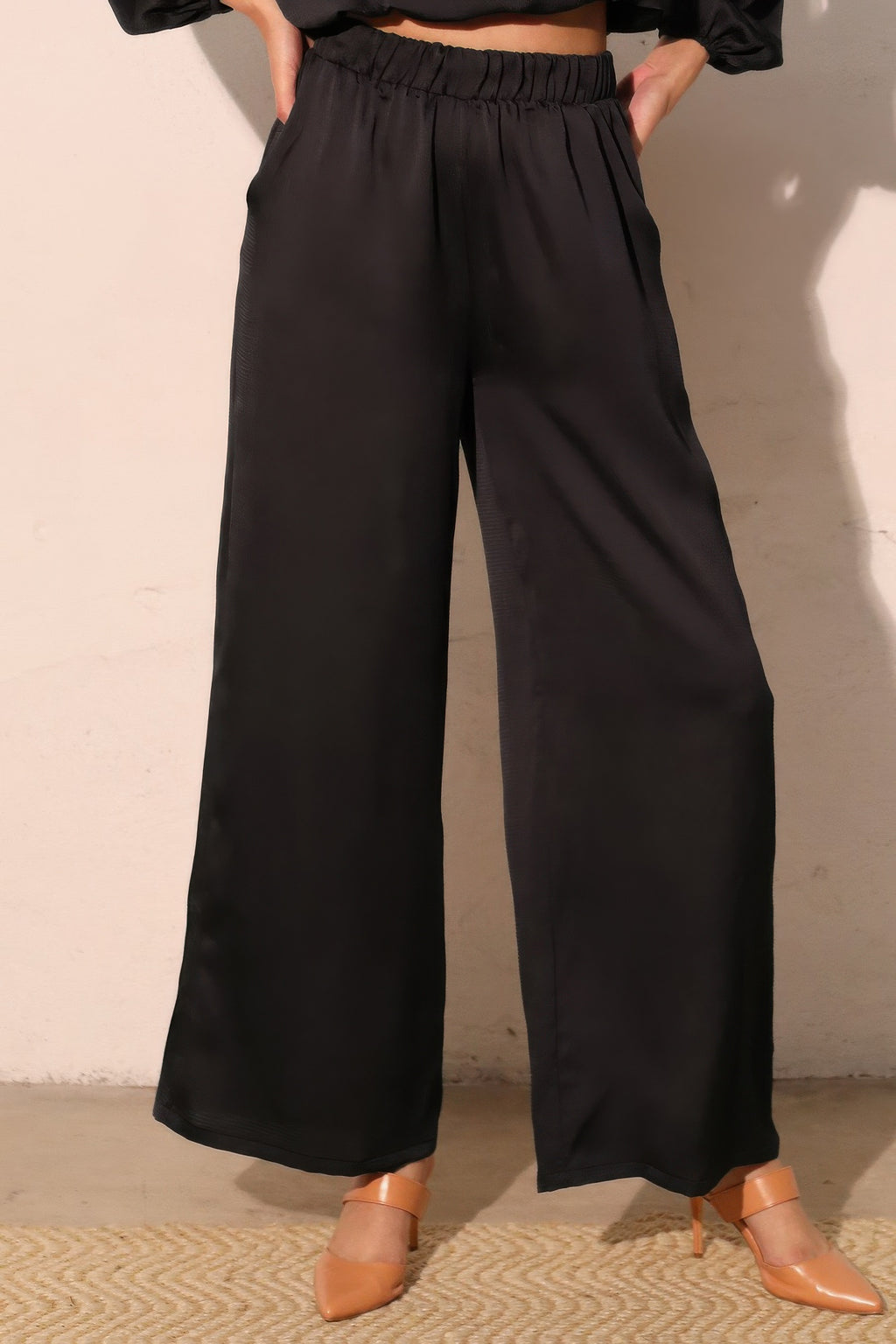 Navy hammered satin pocket pants, back view with gathered elastic waistband and wide legs
