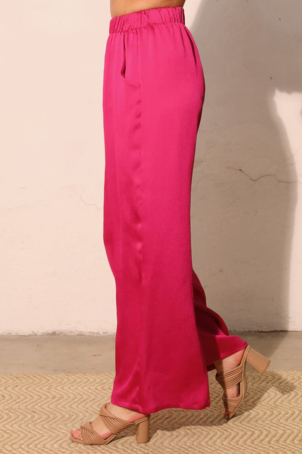 Fuchsia hammered satin pocket pants, back view with elastic waistband and wide legs