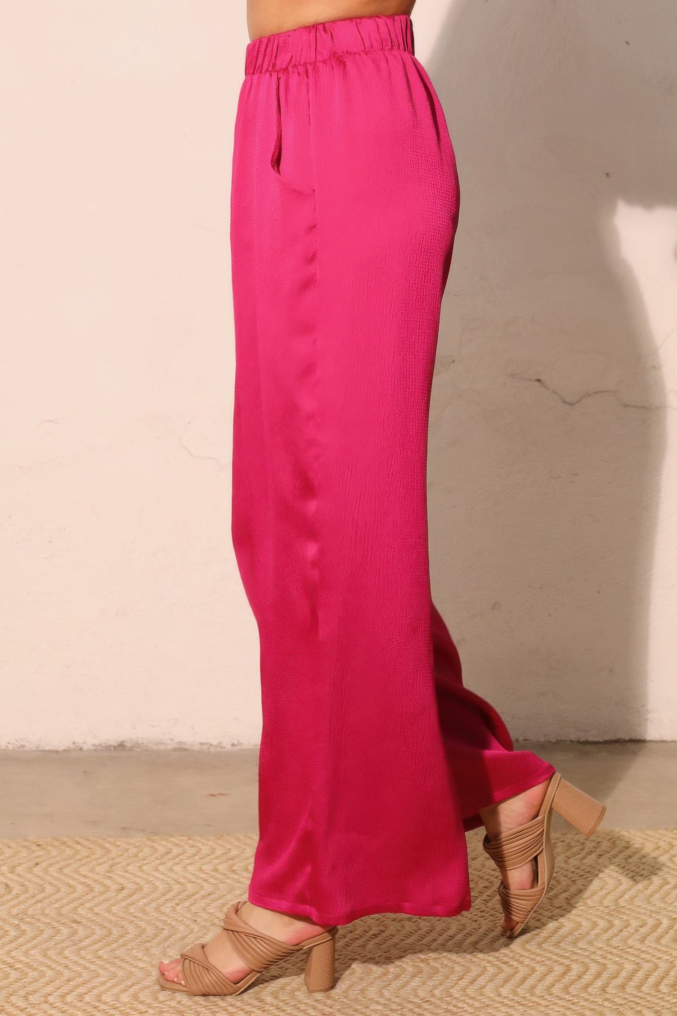 Fuchsia hammered satin pocket pants, back view with elastic waistband and wide legs