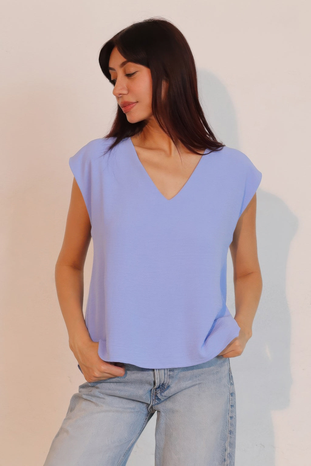 Denim blue matte crepe loose top with V-neck front and relaxed fit.