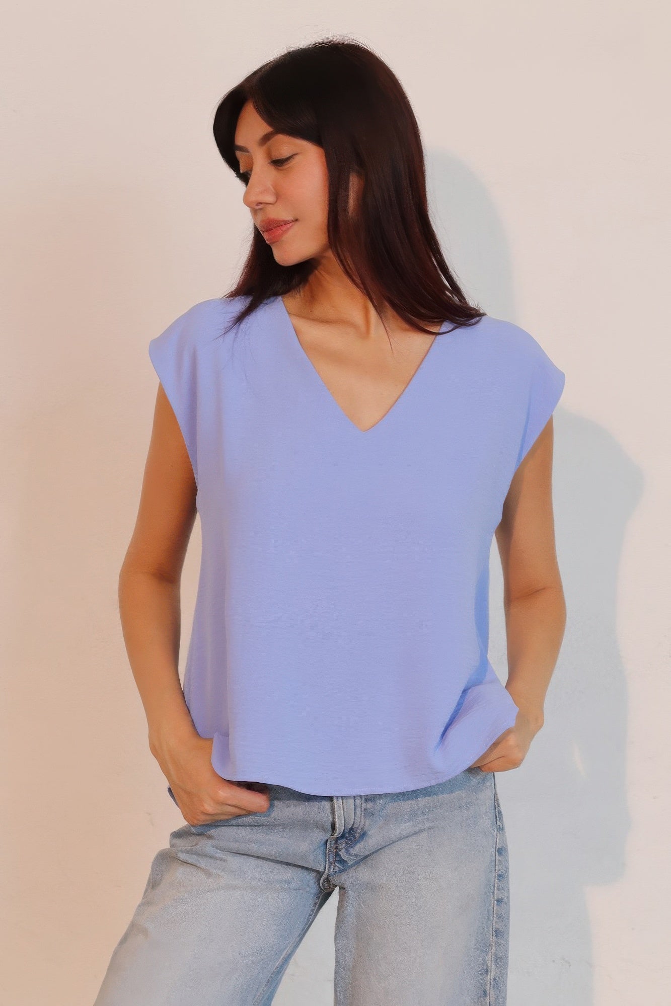 Denim blue matte crepe loose top with V-neck front and relaxed fit.