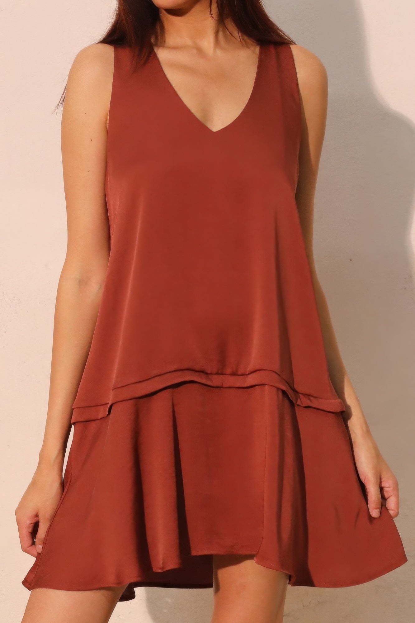 Brown sleeveless V-neck swing dress with tiered ruffle bottom and adjustable waist tie