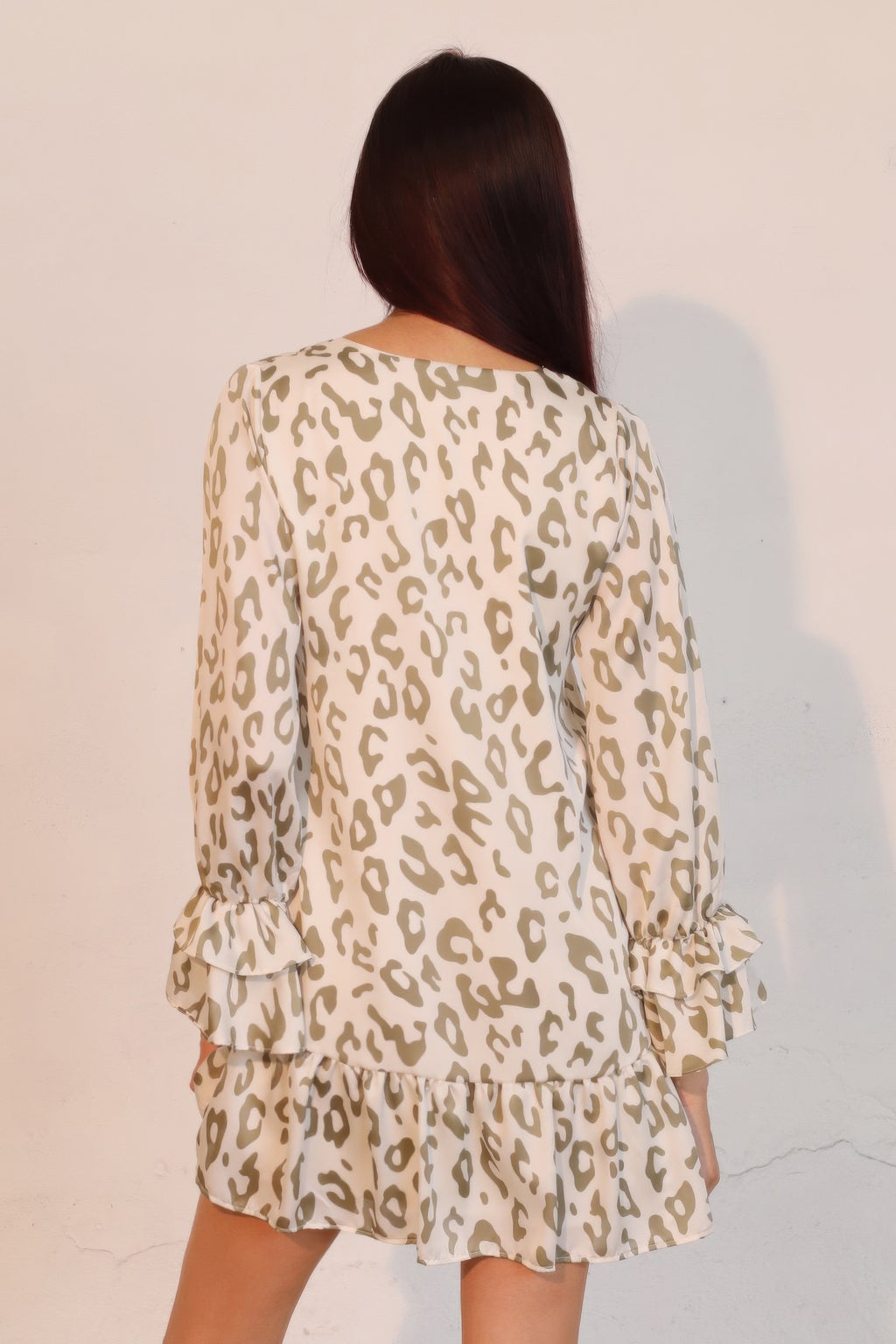 Back view: beige and olive leopard print mini dress with ruffled cuffs and tiered skirt