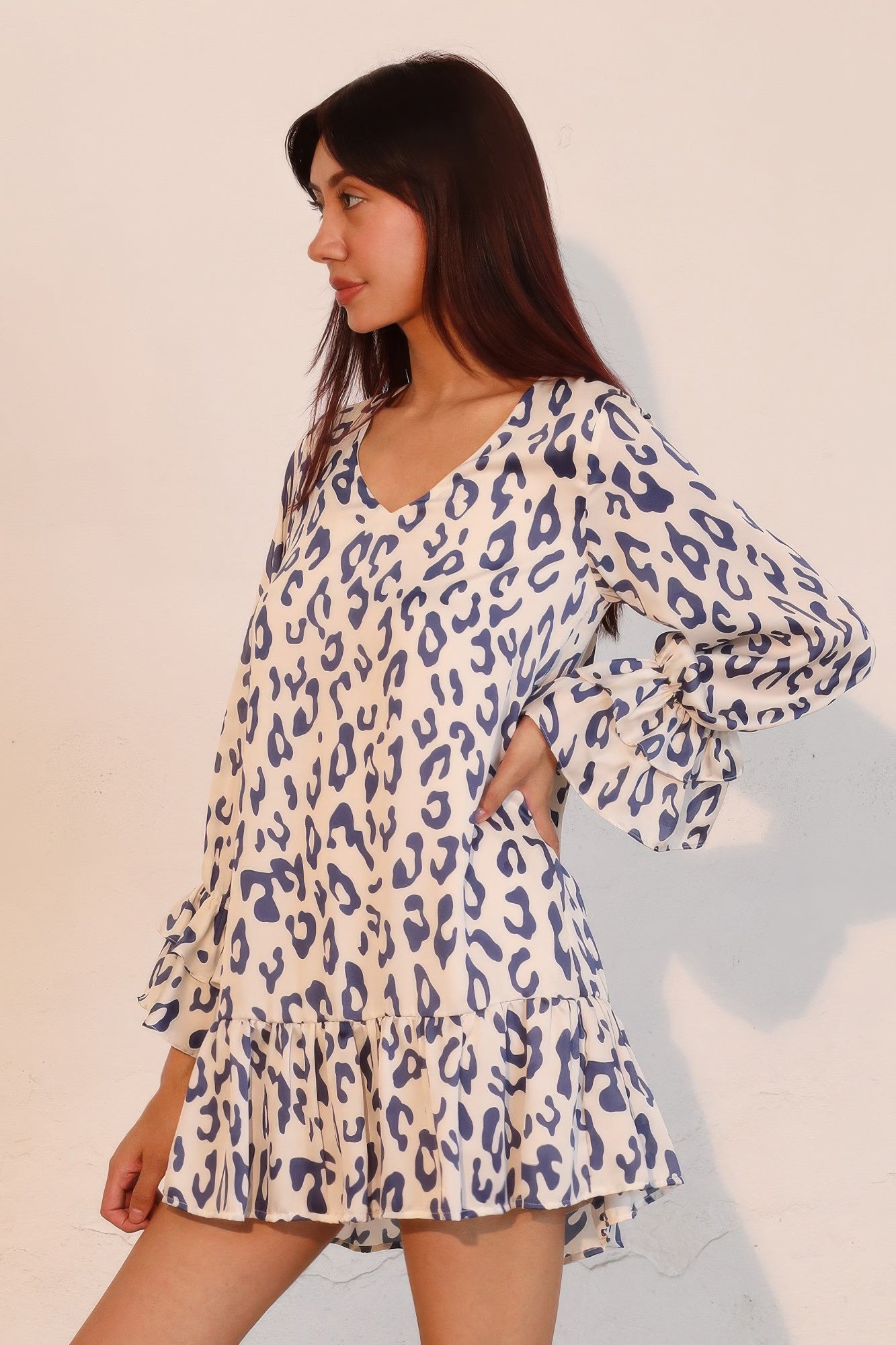 Blue leopard mini dress with V-neck and flowing ruffle sleeves, tiered skirt