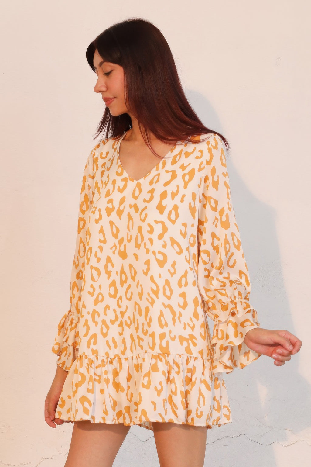 Gold leopard mini dress with V-neck, tiered skirt, long balloon sleeves and ruffle cuffs
