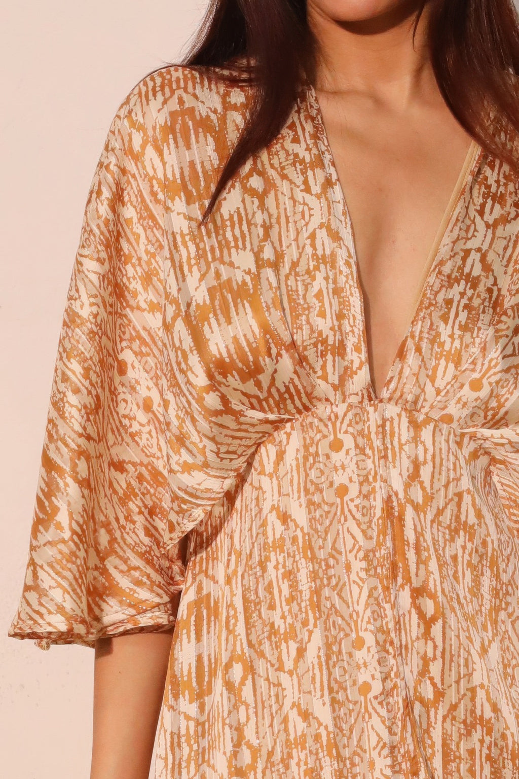 Lurex chiffon cape maxi dress close-up, V-neck with gathered detail, patterned fabric