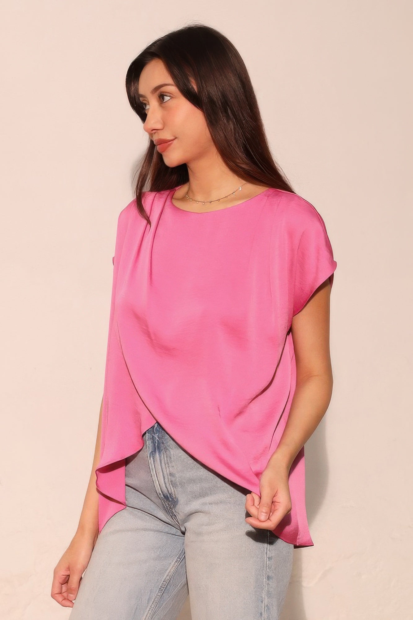Pink tulip tunic top with draped V-front and short sleeves, side angle