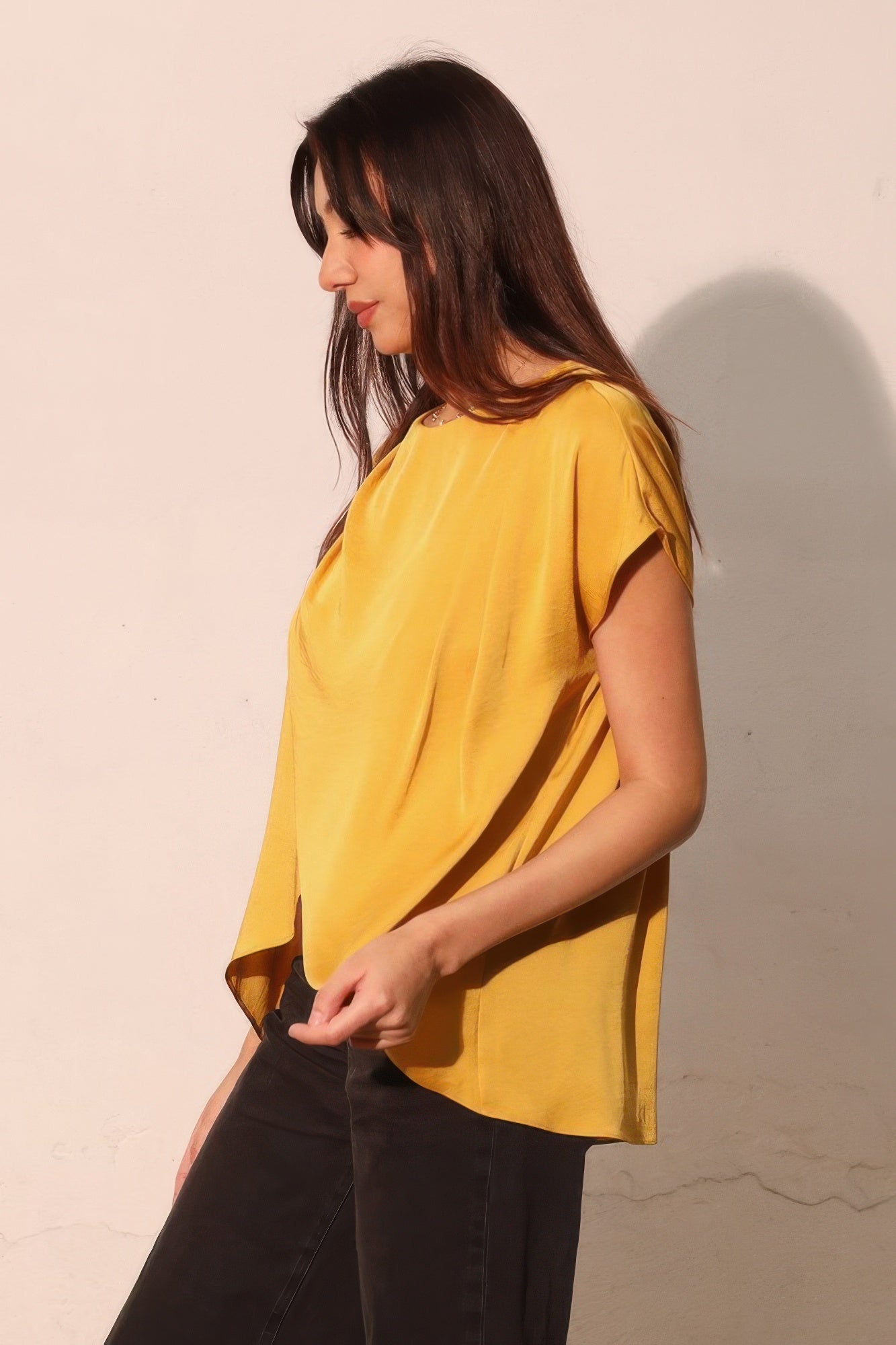Mustard yellow washed poly silk tunic top, crossover drape and tulip hem, side view