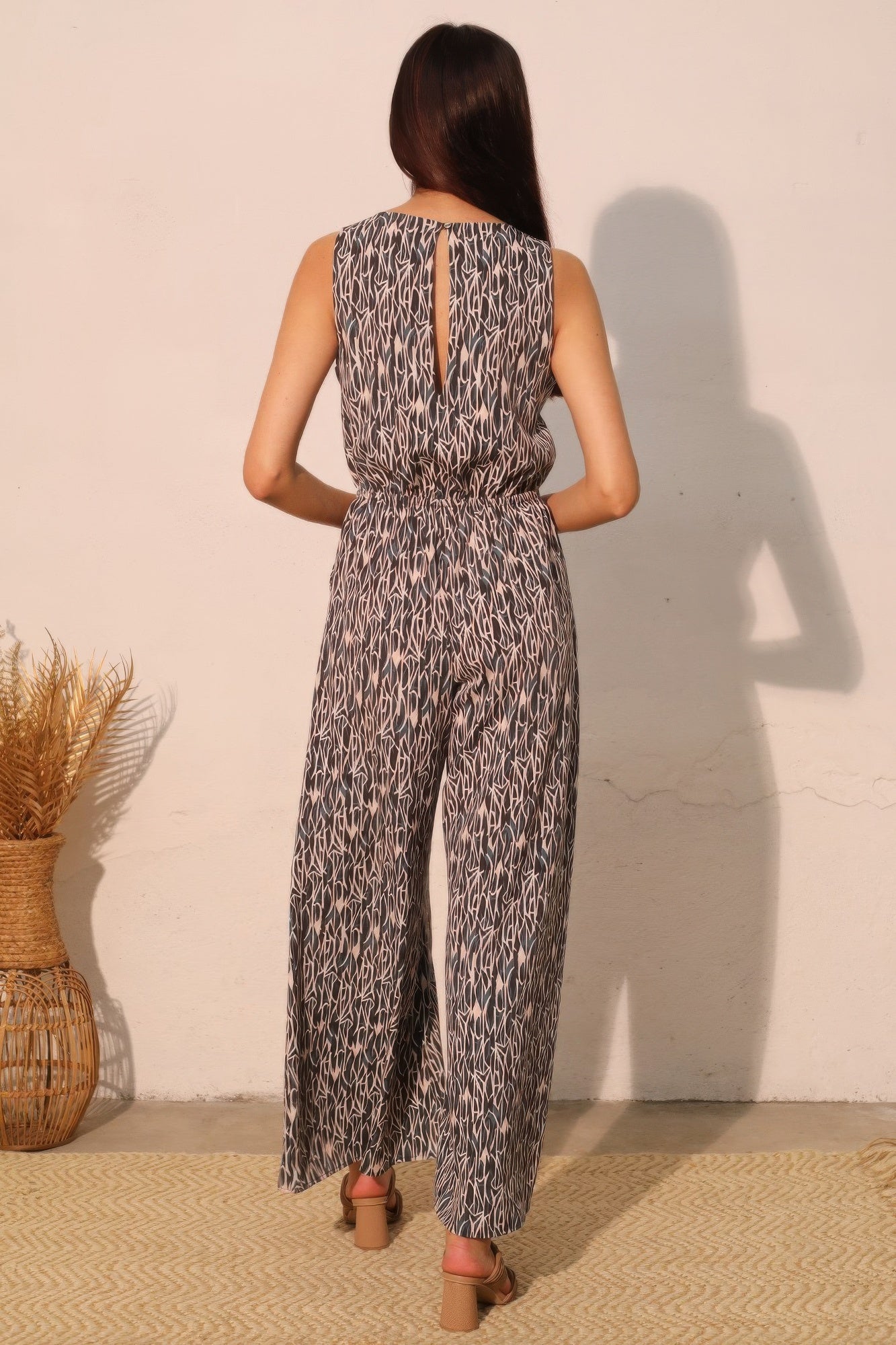Night Meadow sleeveless bubble jumpsuit back view showing wide-leg drape and print
