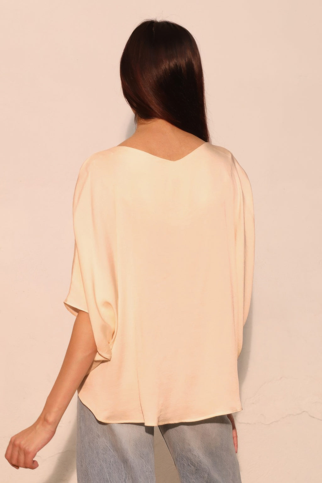 Washed poly-silk dolman top, champagne, back view with loose dolman sleeves