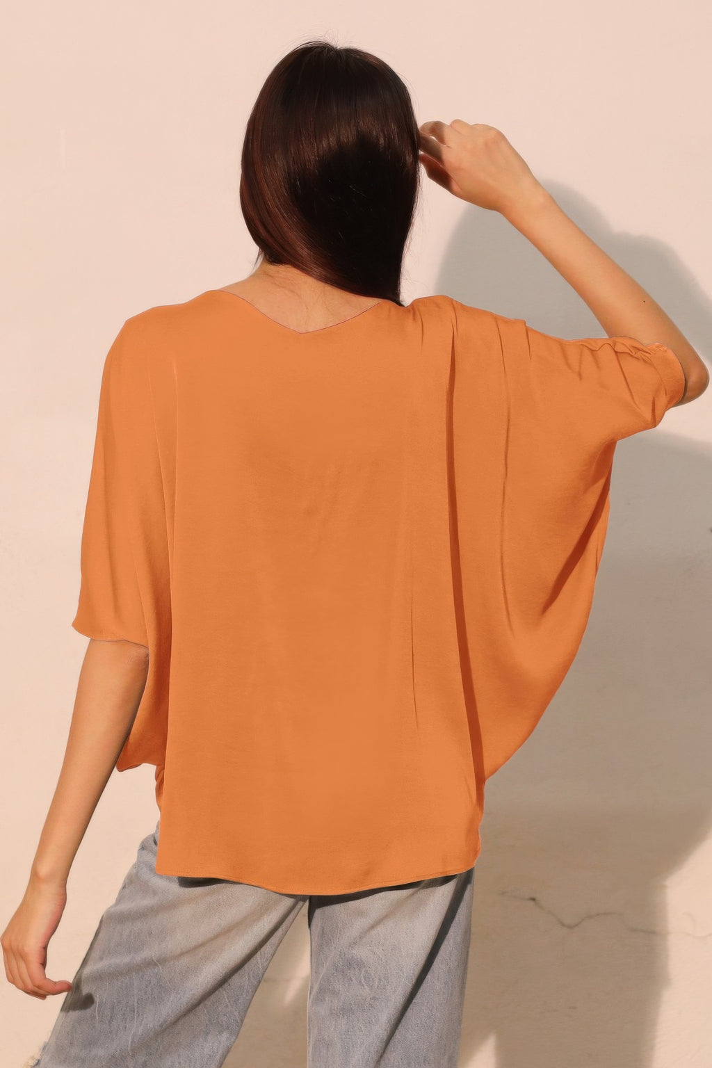 Washed poly-silk dolman top, pumpkin, back view with dolman sleeves