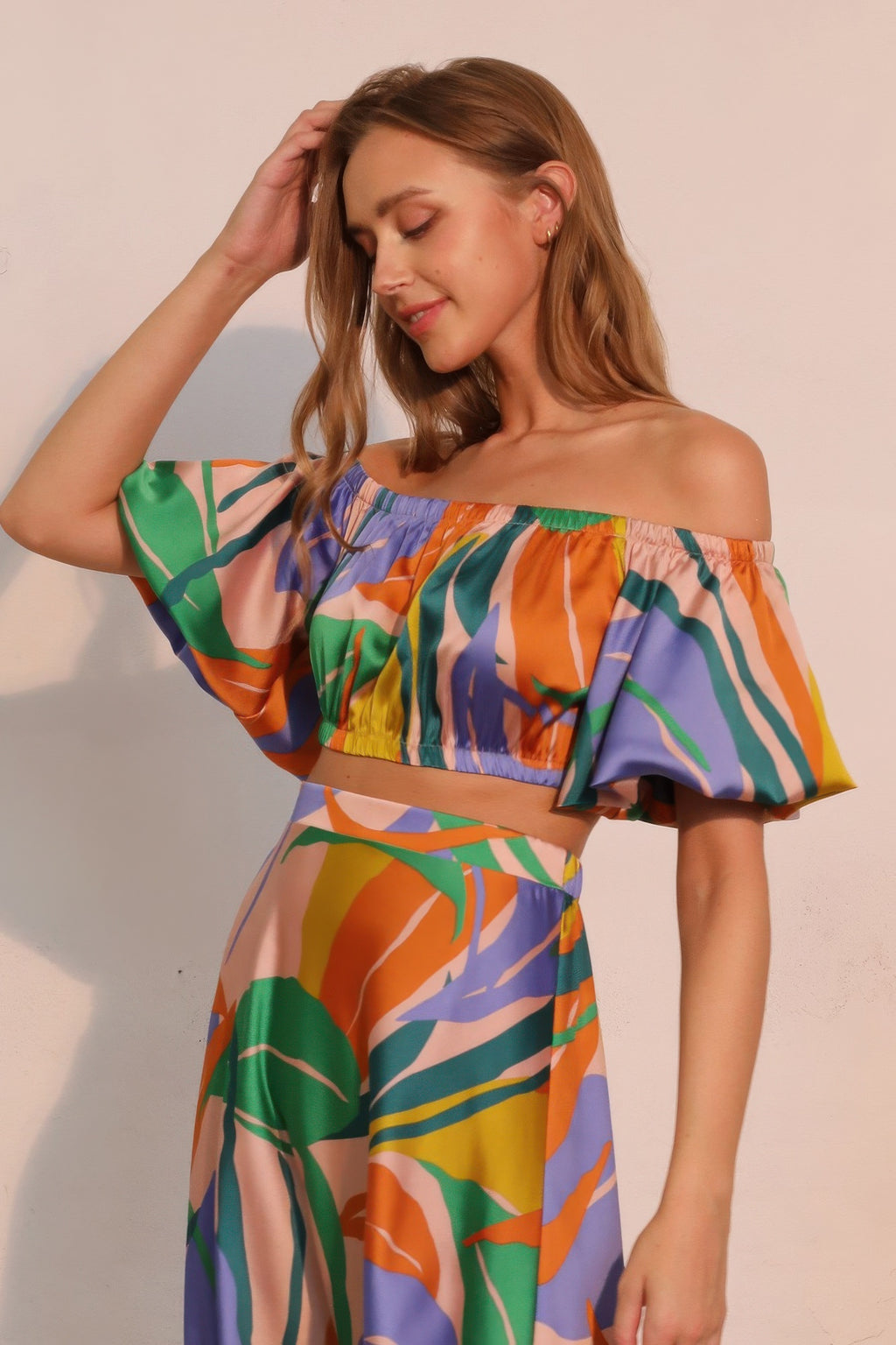 Off-shoulder satin crop top with gathered neckline, bubble sleeves, tropical multicolor print