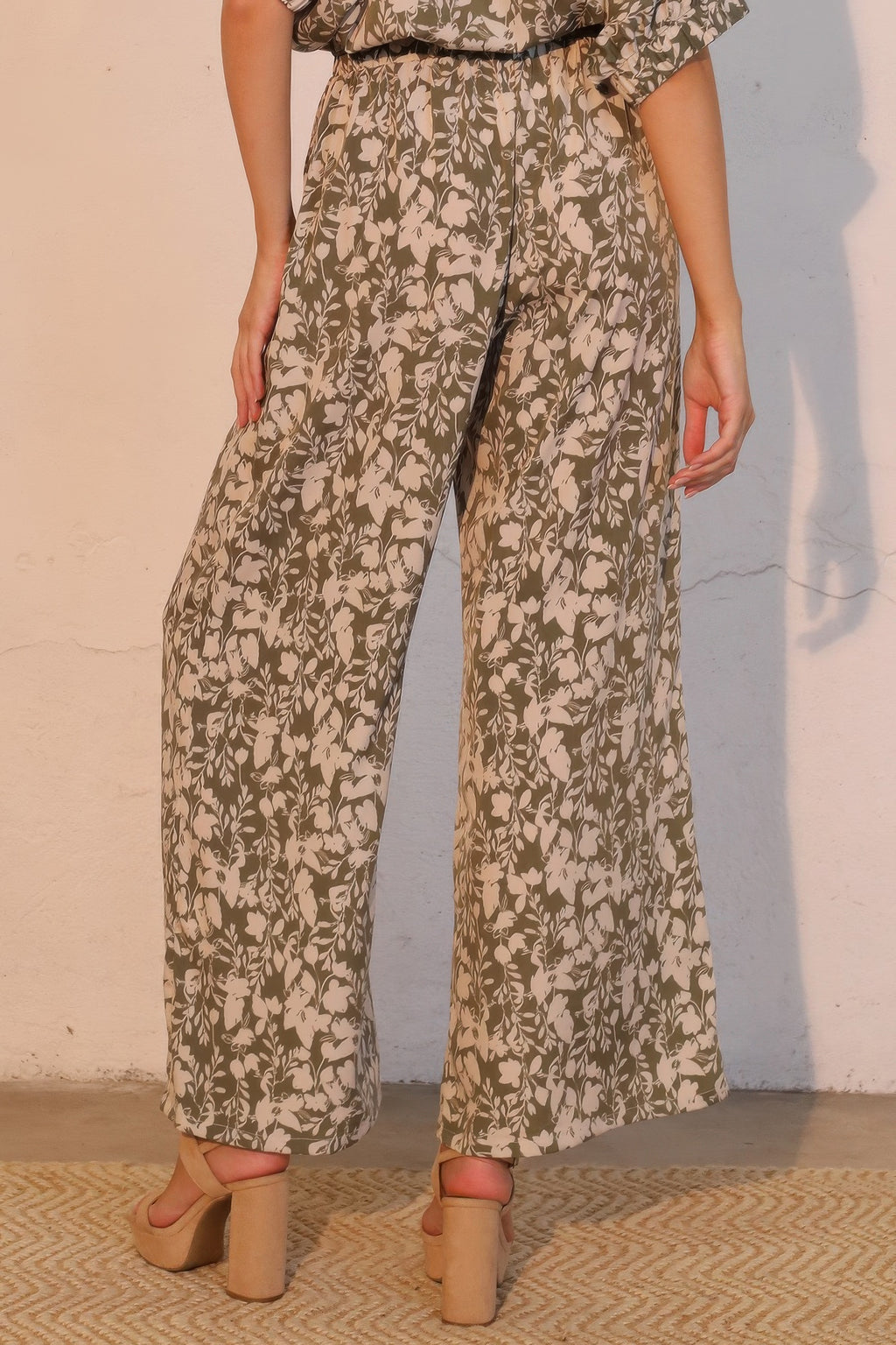 Olive-toned floral wide-leg pants with side pockets and relaxed fit
