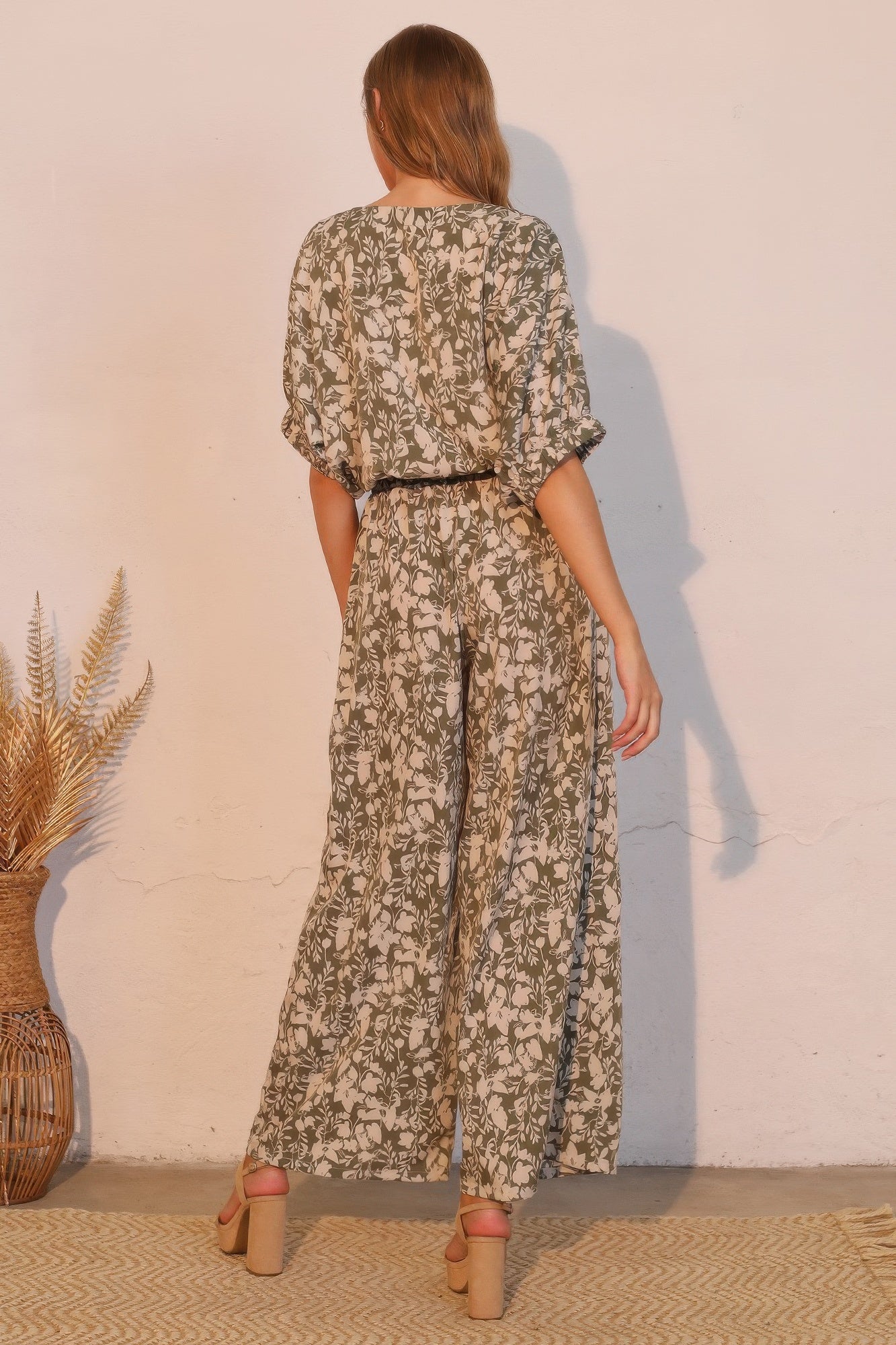 Back view: olive floral wide-leg pocket pants with elastic waistband