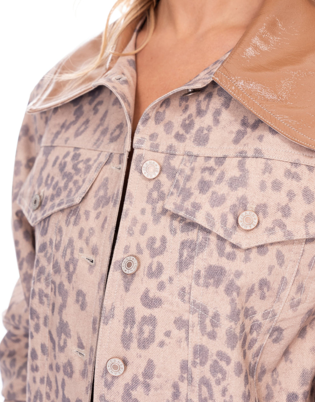Leopard print denim jacket close-up: button placket and chest flap pockets