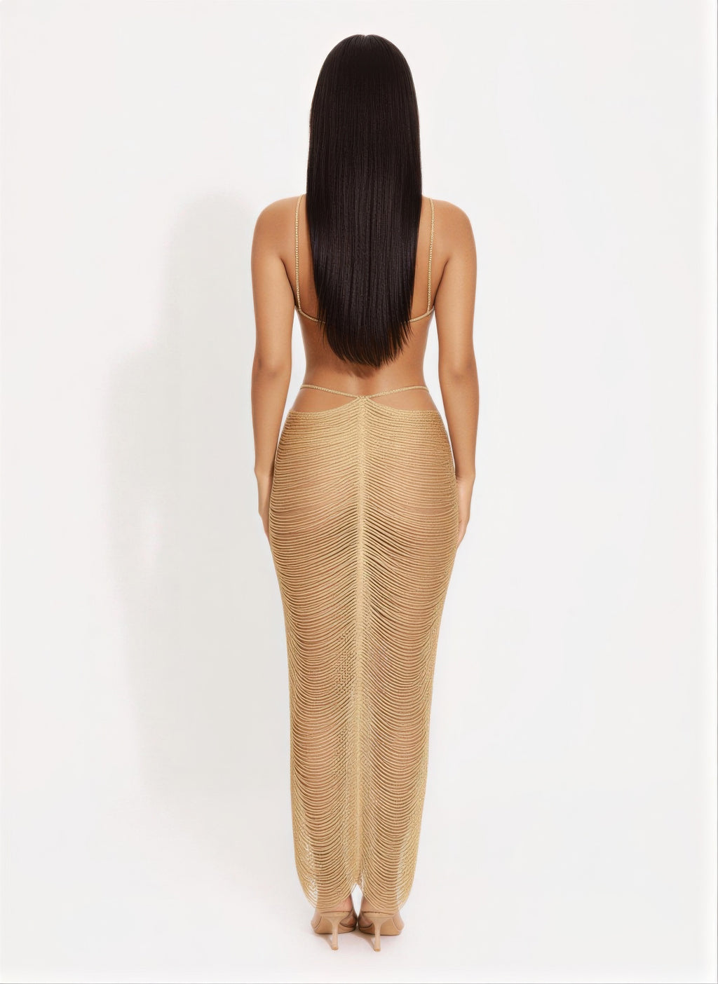 Back view of gold metallic cutout maxi dress with crisscross straps and draped long skirt