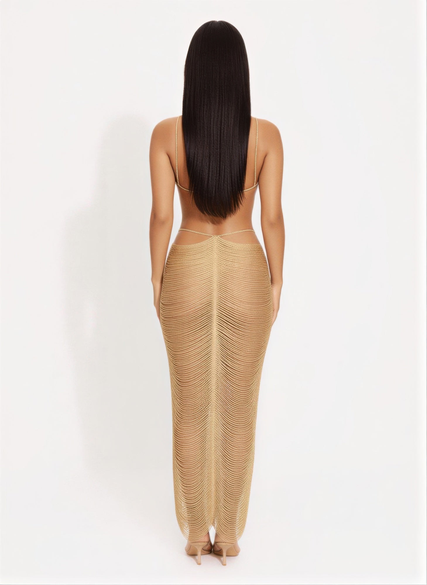 Back view of gold metallic cutout maxi dress with crisscross straps and draped long skirt