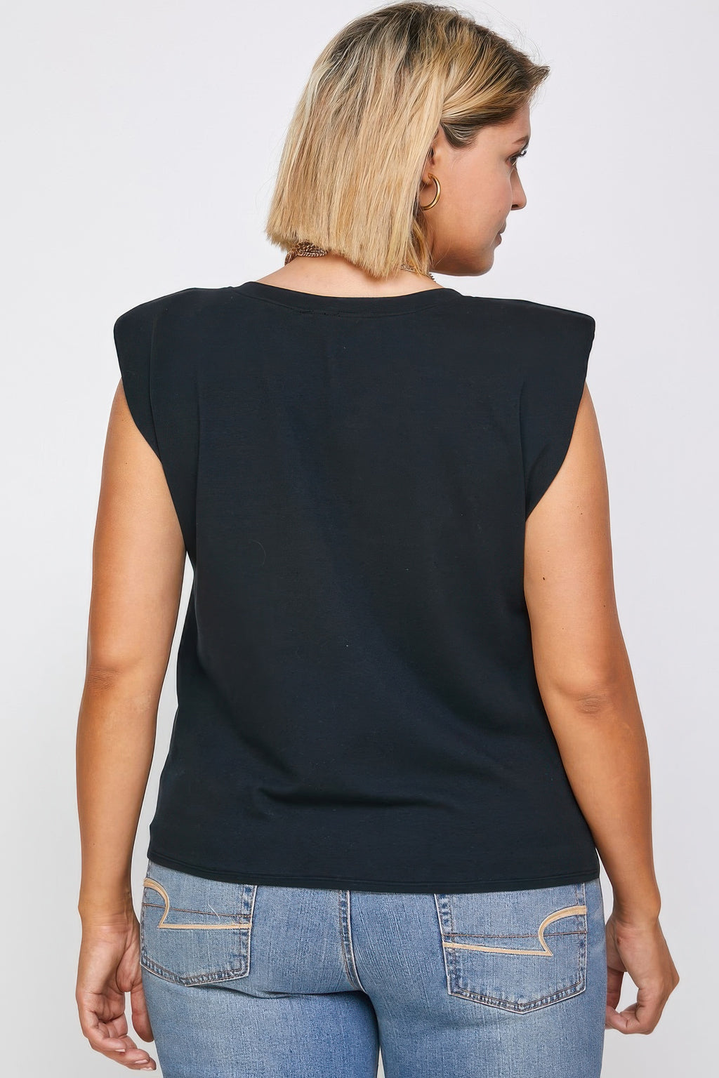 Back of padded shoulder top in dark knit, plain neckline