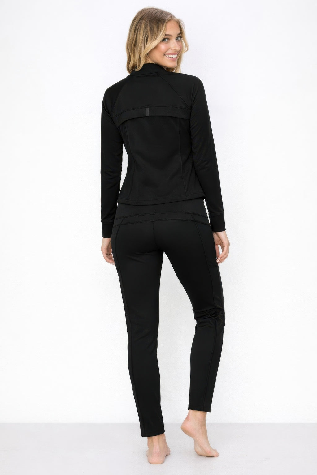 Black zip-up athletic jacket with matching lounge pants, back view