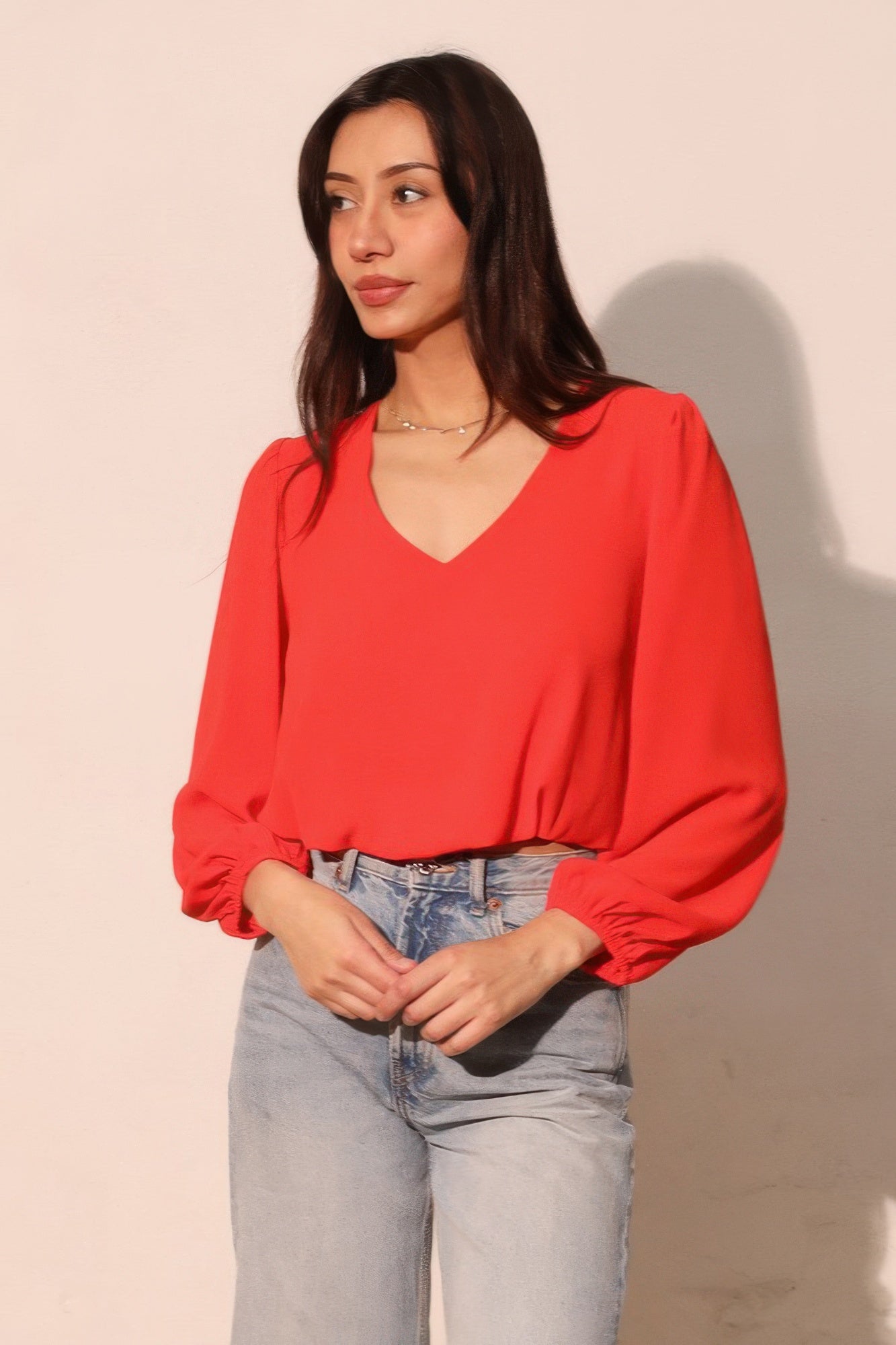 Tomato red V-neck textured long-sleeve crop top with puff sleeves and ruched cuffs