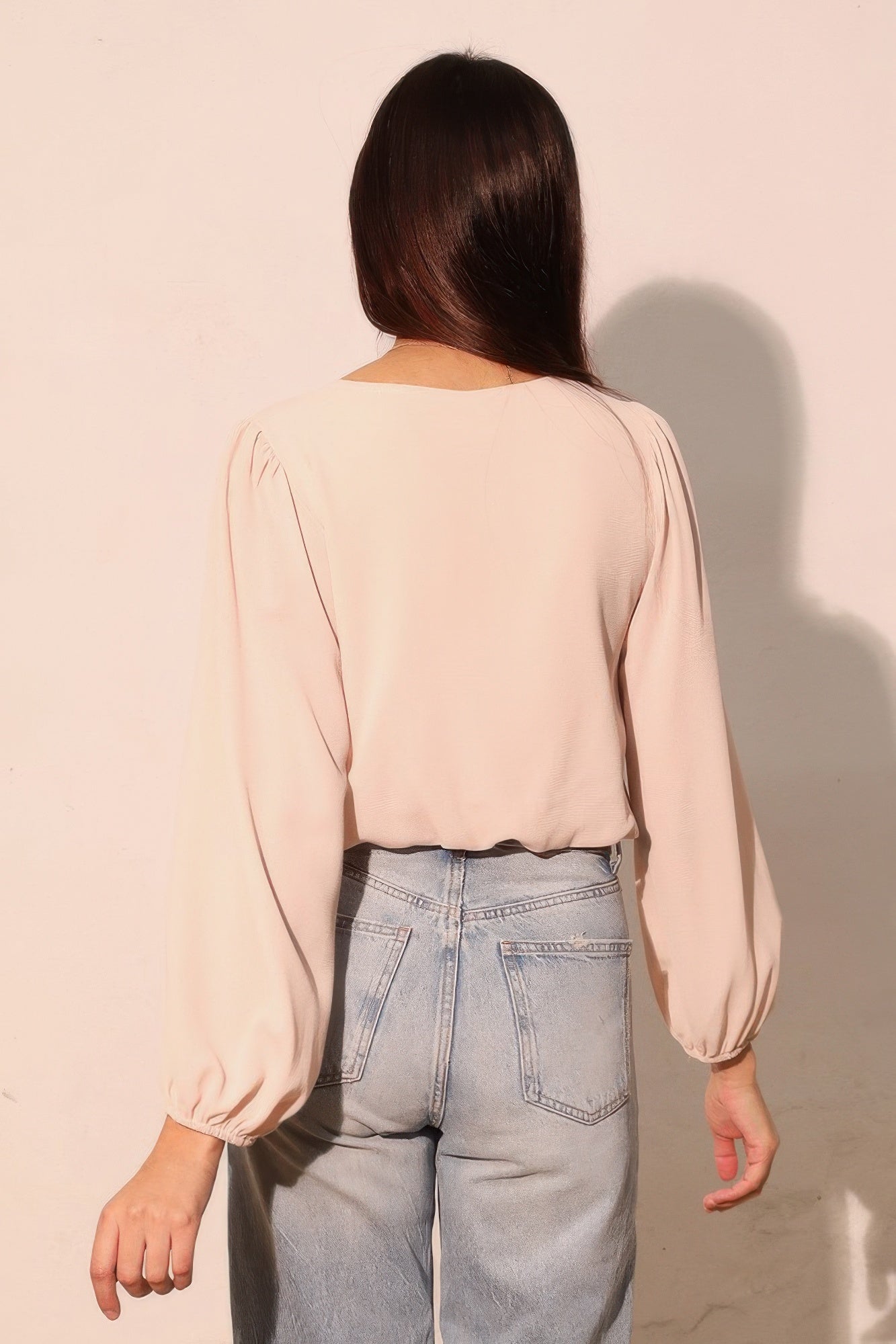 Champagne back view: long-sleeve crop top with voluminous sleeves and cuff ruching