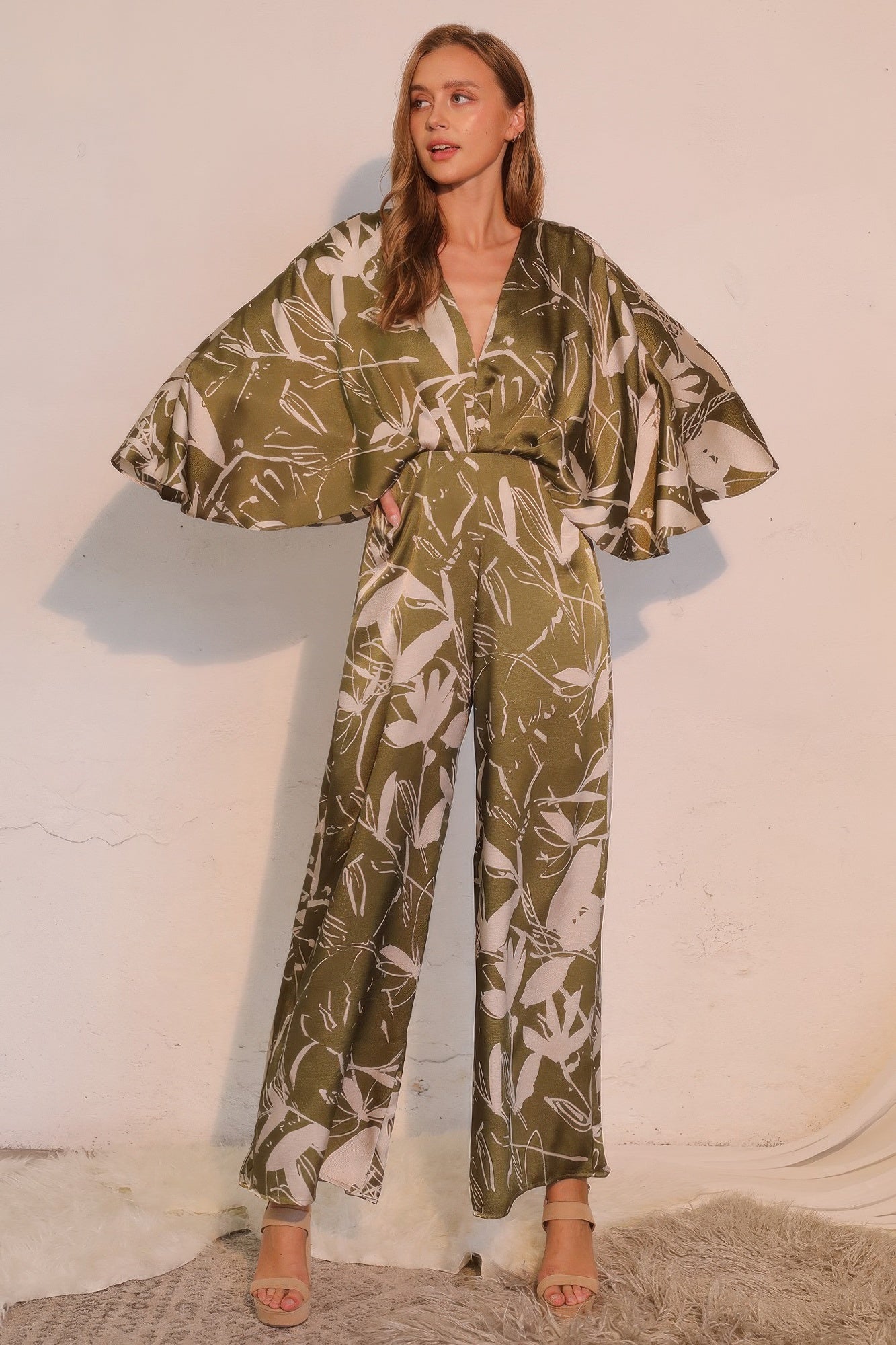 Olive satin cape jumpsuit with V-neck and flowing wide-leg pants