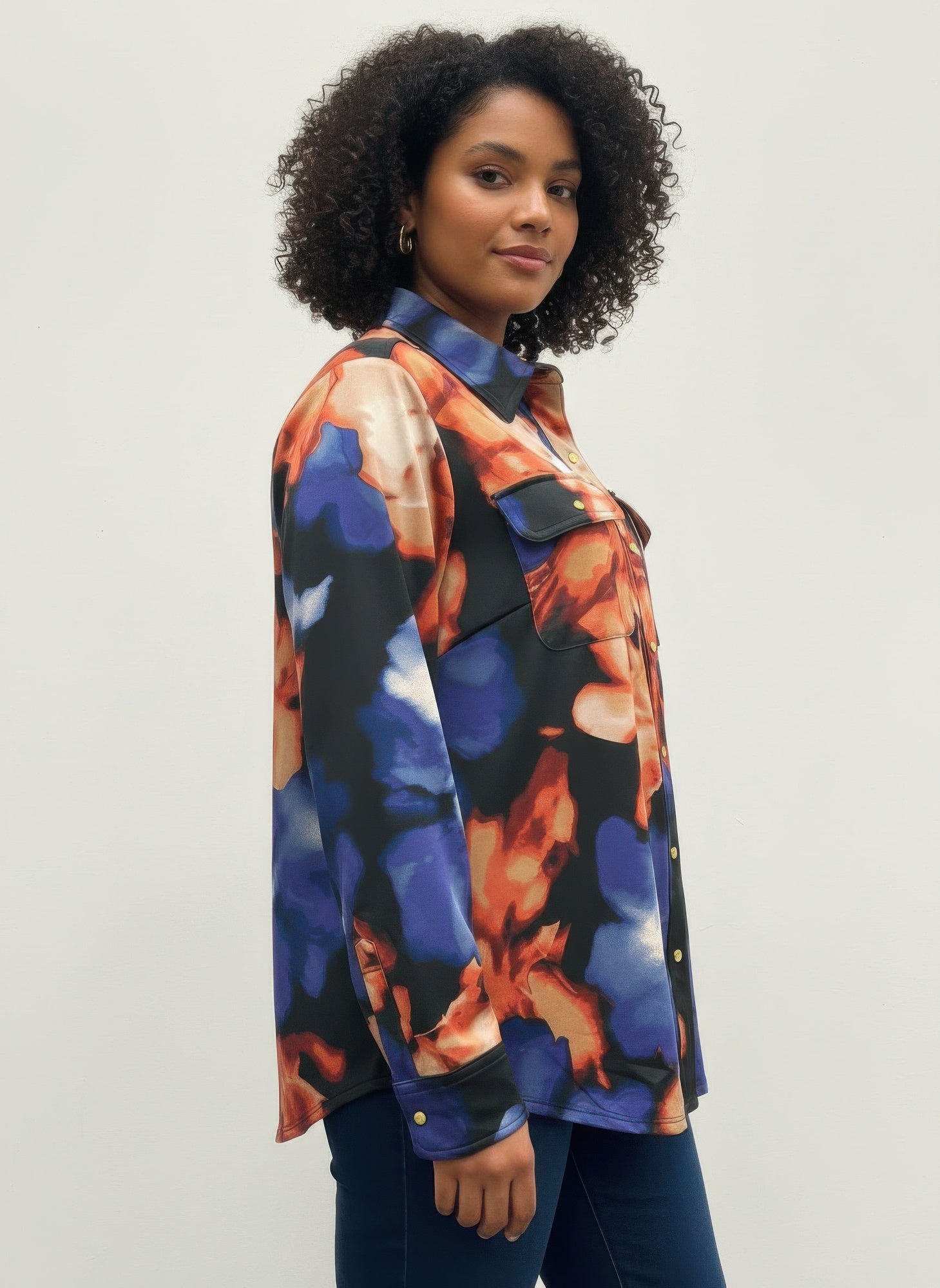 Thomas & Olivia blouse in abstract blue, orange, and black print; button-up with collar