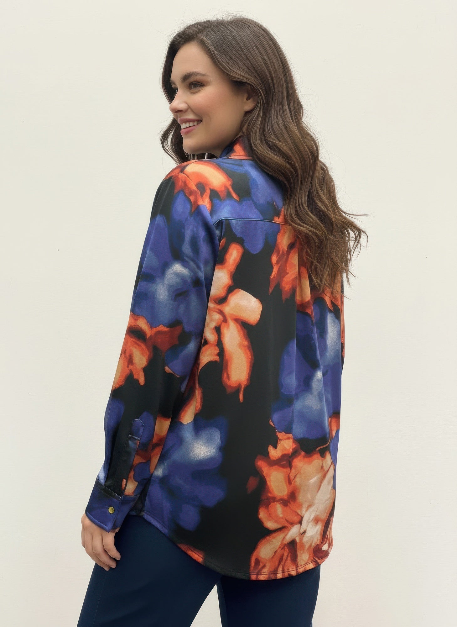 Thomas & Olivia blouse side view, long sleeves, abstract blue-and-orange print with button placket
