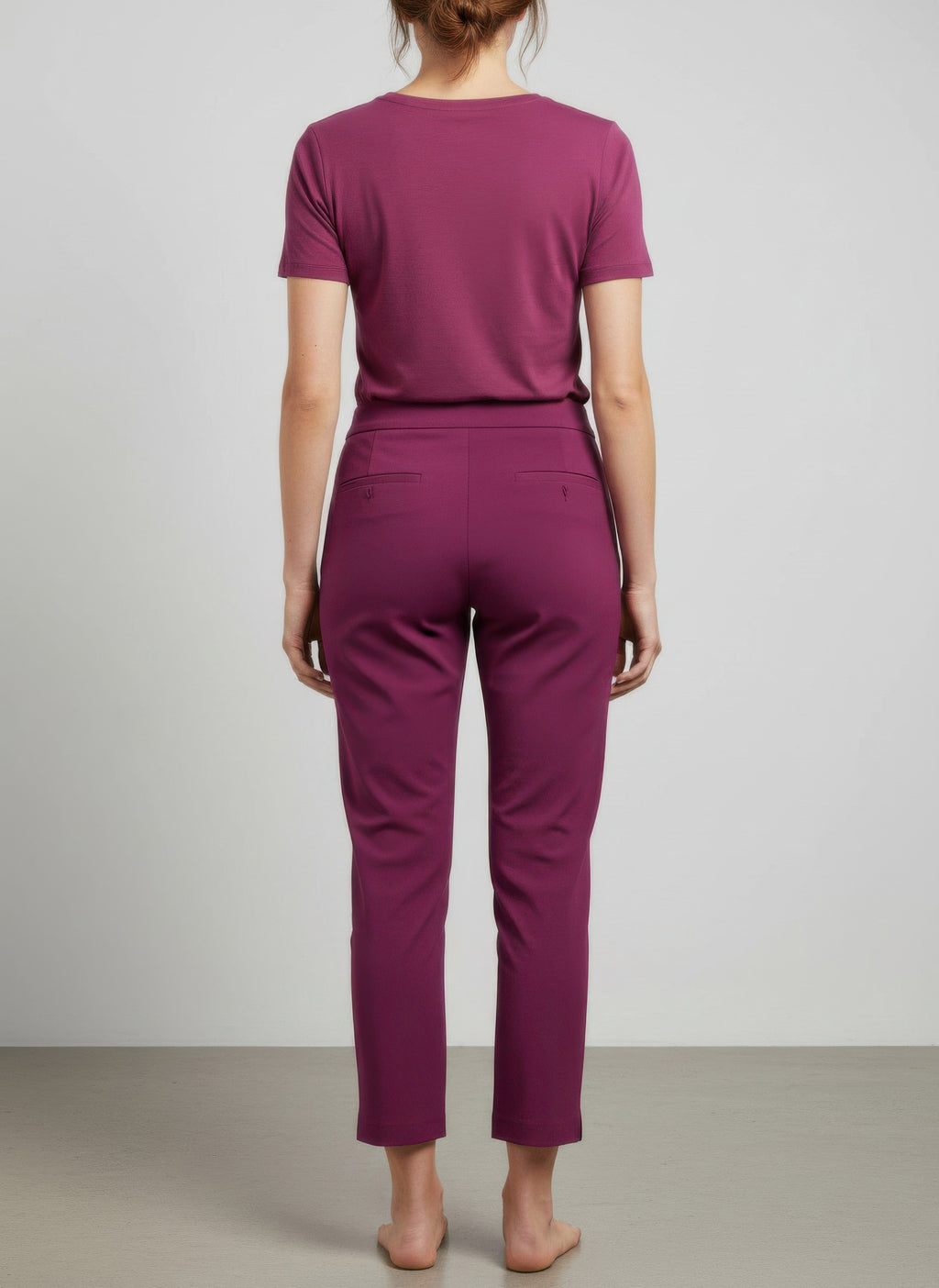 Back view of magenta pull-on pants, tapered ankle-length legs