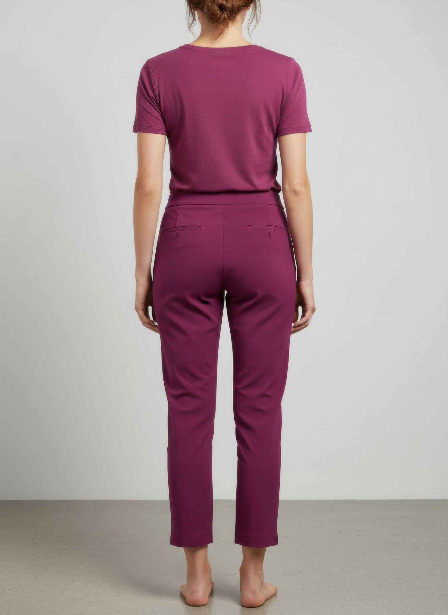 Back view of magenta pull-on pants, tapered ankle-length legs