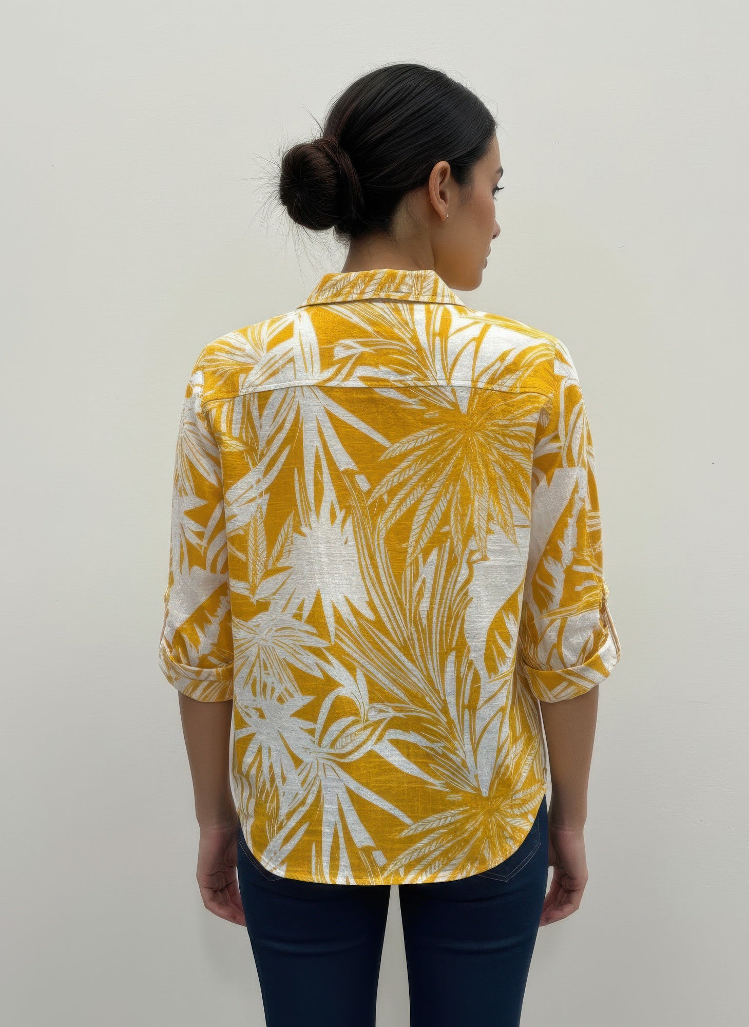 Back view of yellow and white leaf-print blouse with 3/4 sleeves