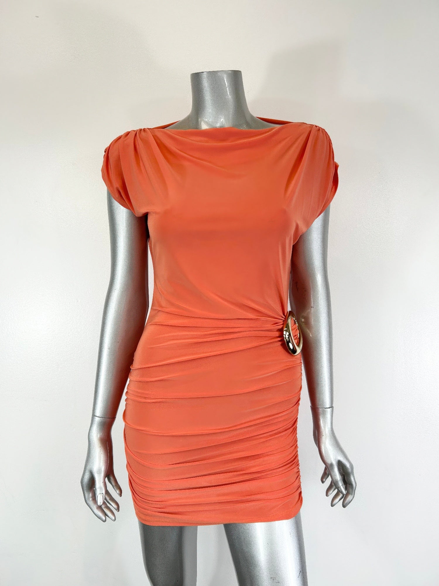 Orange ruched mini dress on mannequin, puffed cap sleeves and side circular ring