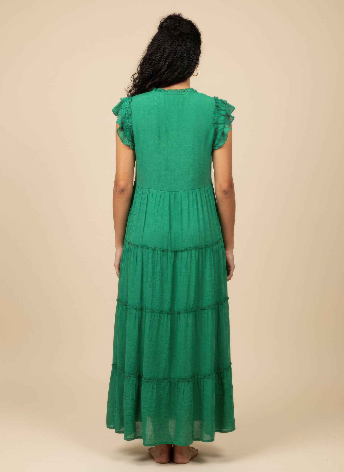 Solid green cap-sleeve tiered dress, back view, tiered skirt tiers