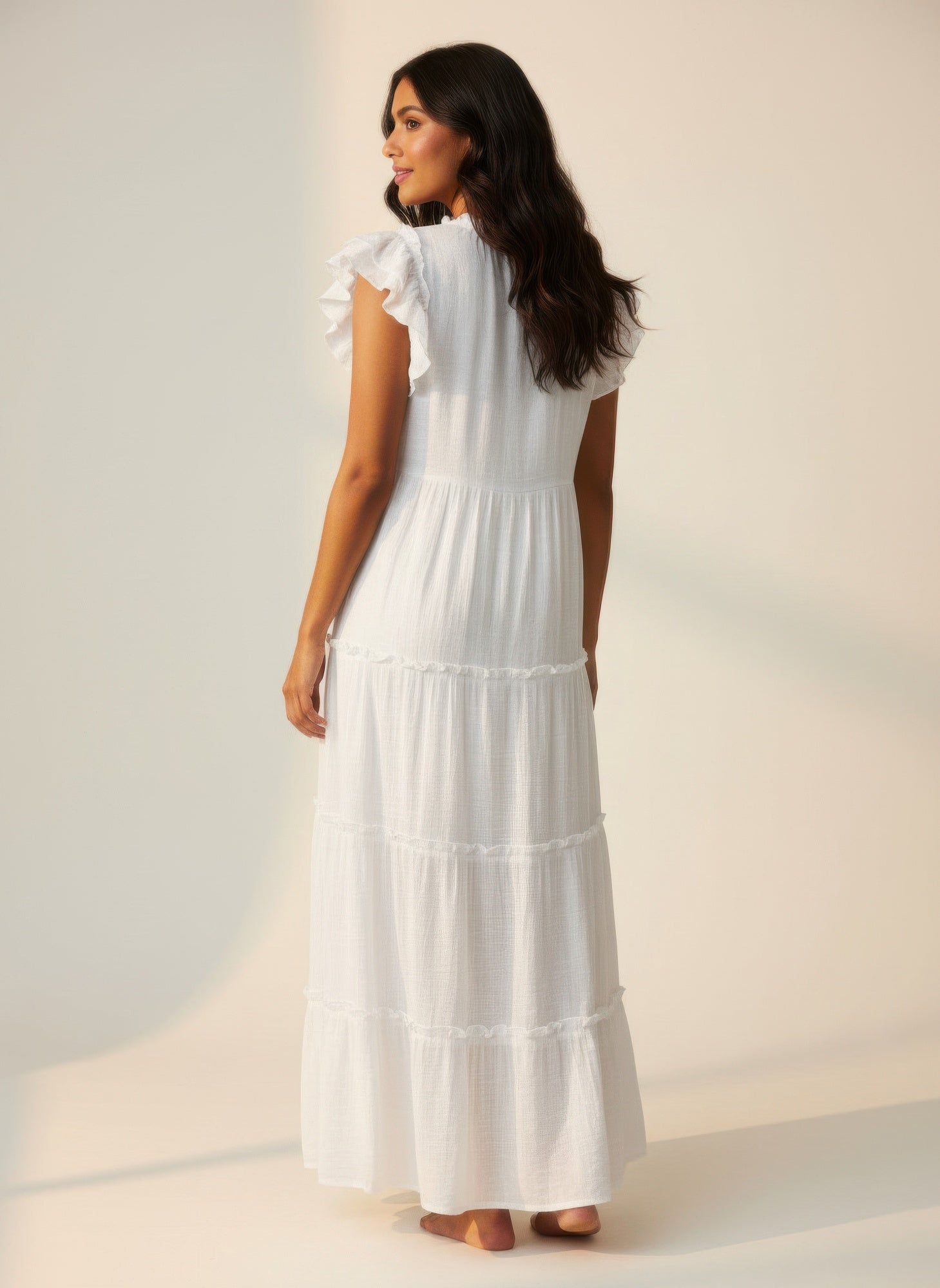Solid white cap-sleeve tiered dress, back view, tiered skirt and tassel tie