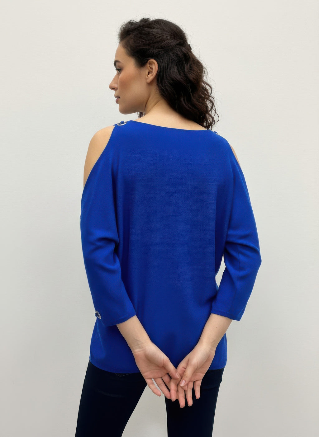 Royal blue cable knit pullover sweater, back view with open shoulder and grommet accents