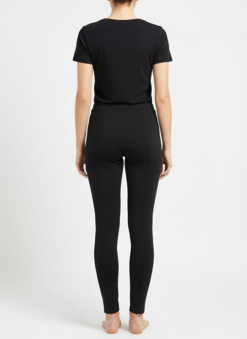 Back view: black solid pull-on pants with ankle-length tapered legs