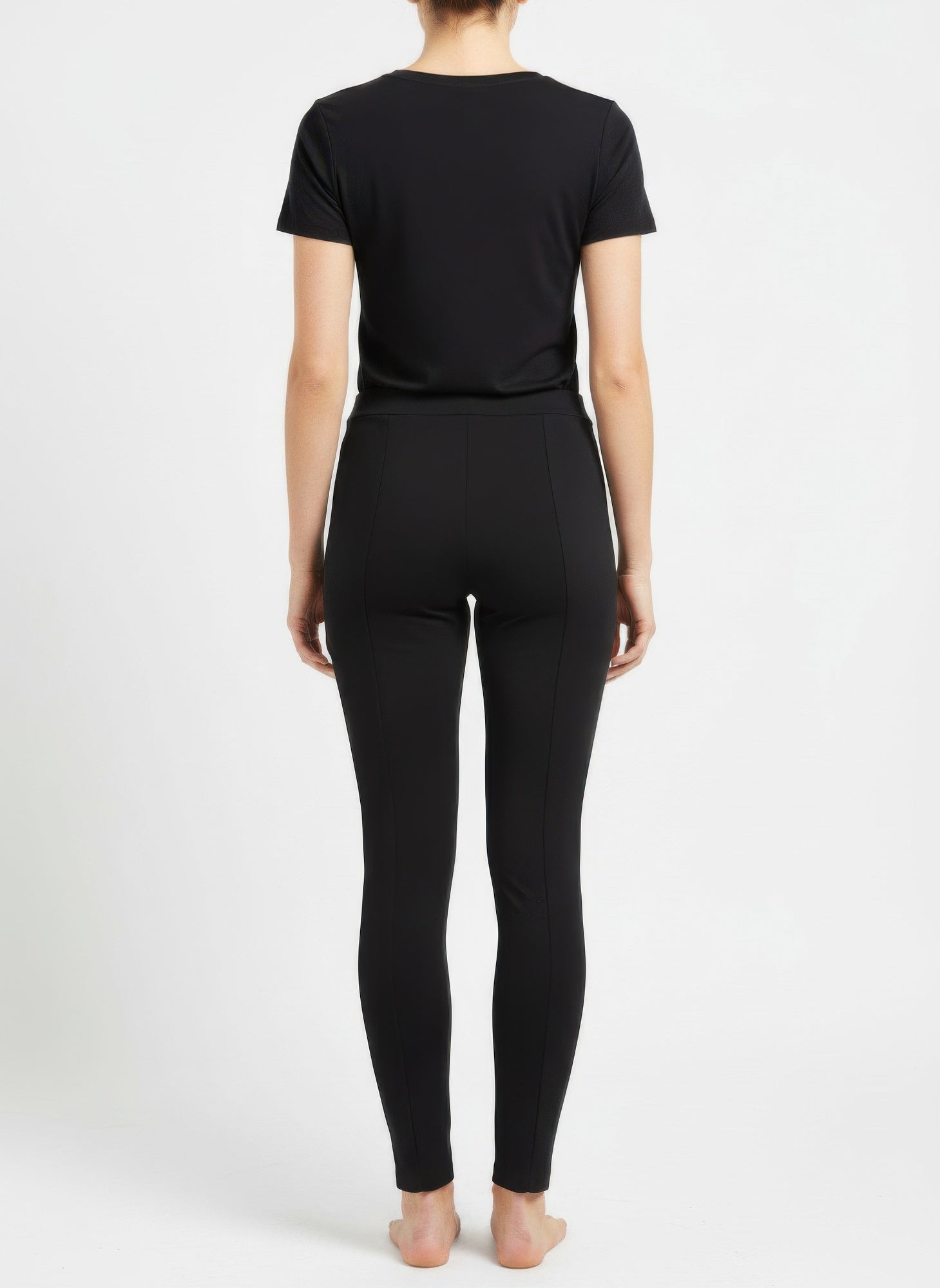 Back view: black solid pull-on pants with ankle-length tapered legs