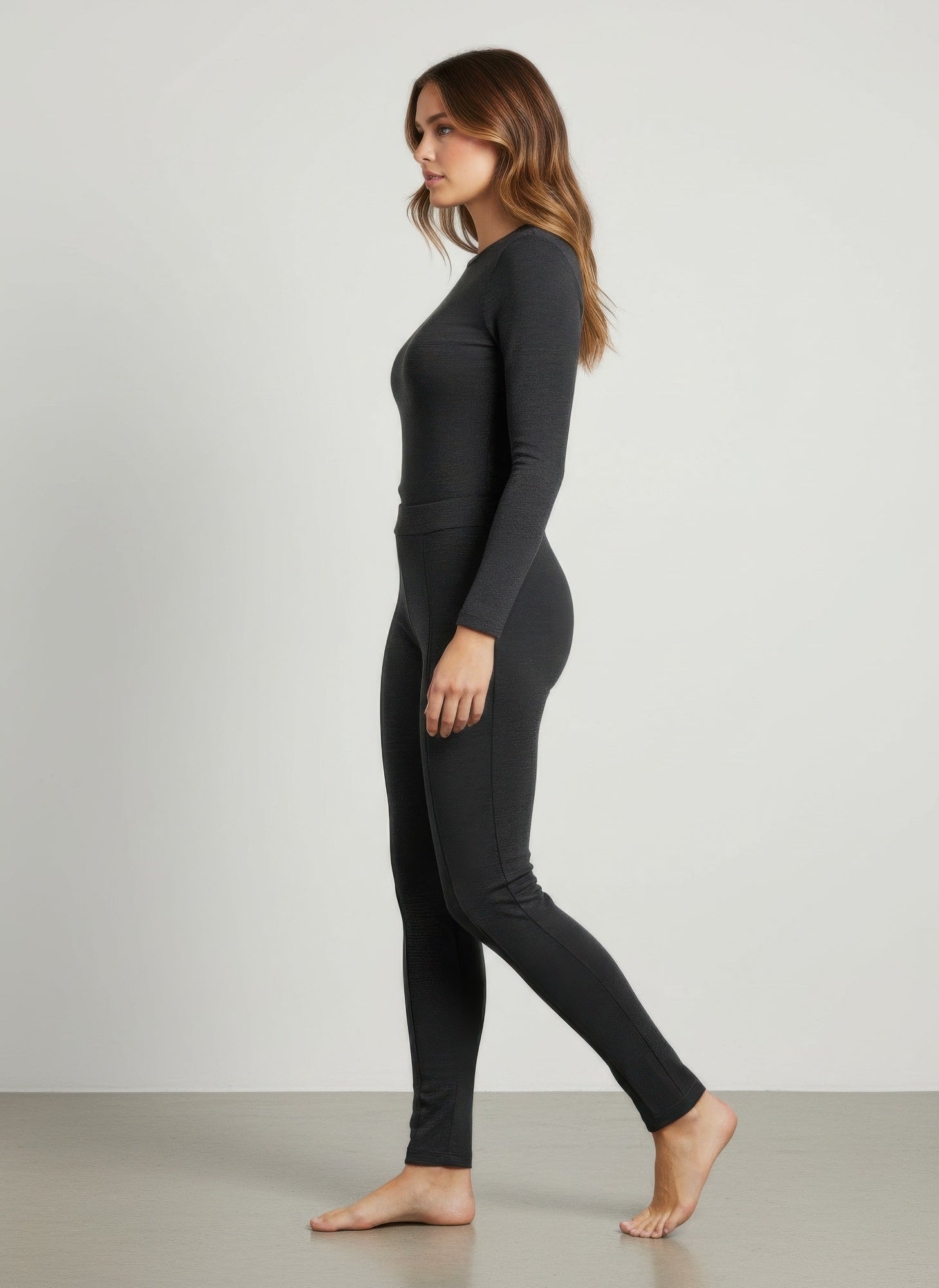 Side view of solid pull-on pants in dark charcoal with tapered legs