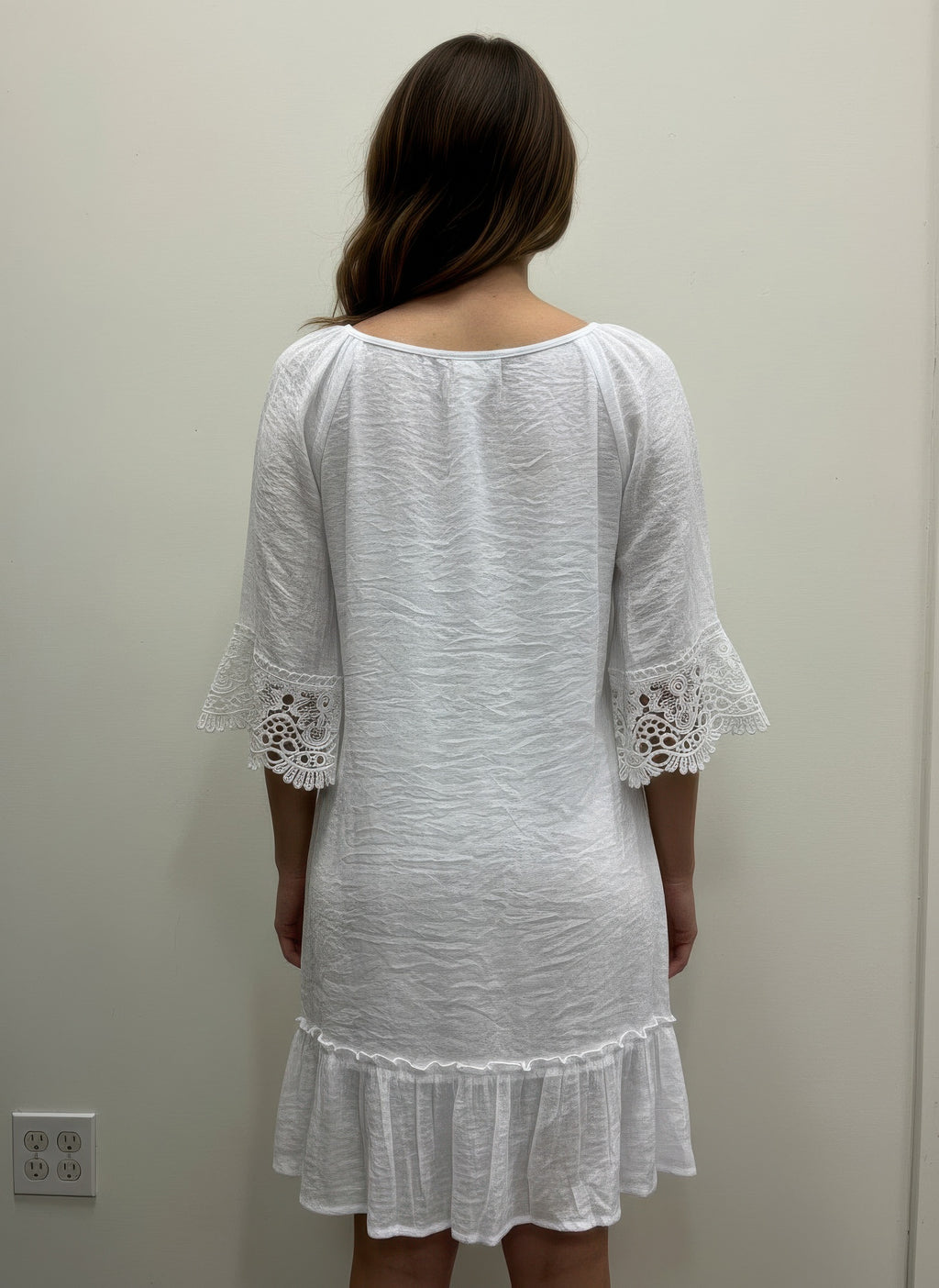 White dress back view, lace elbow sleeves and tiered ruffle hem