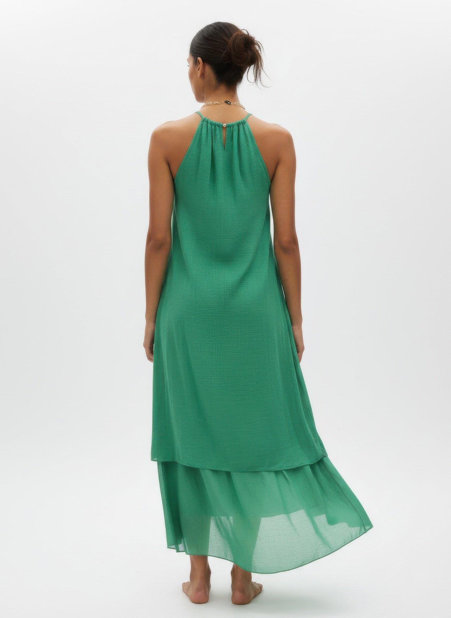 Green sleeveless midi dress, back view, halter neckline with tie and tiered layers
