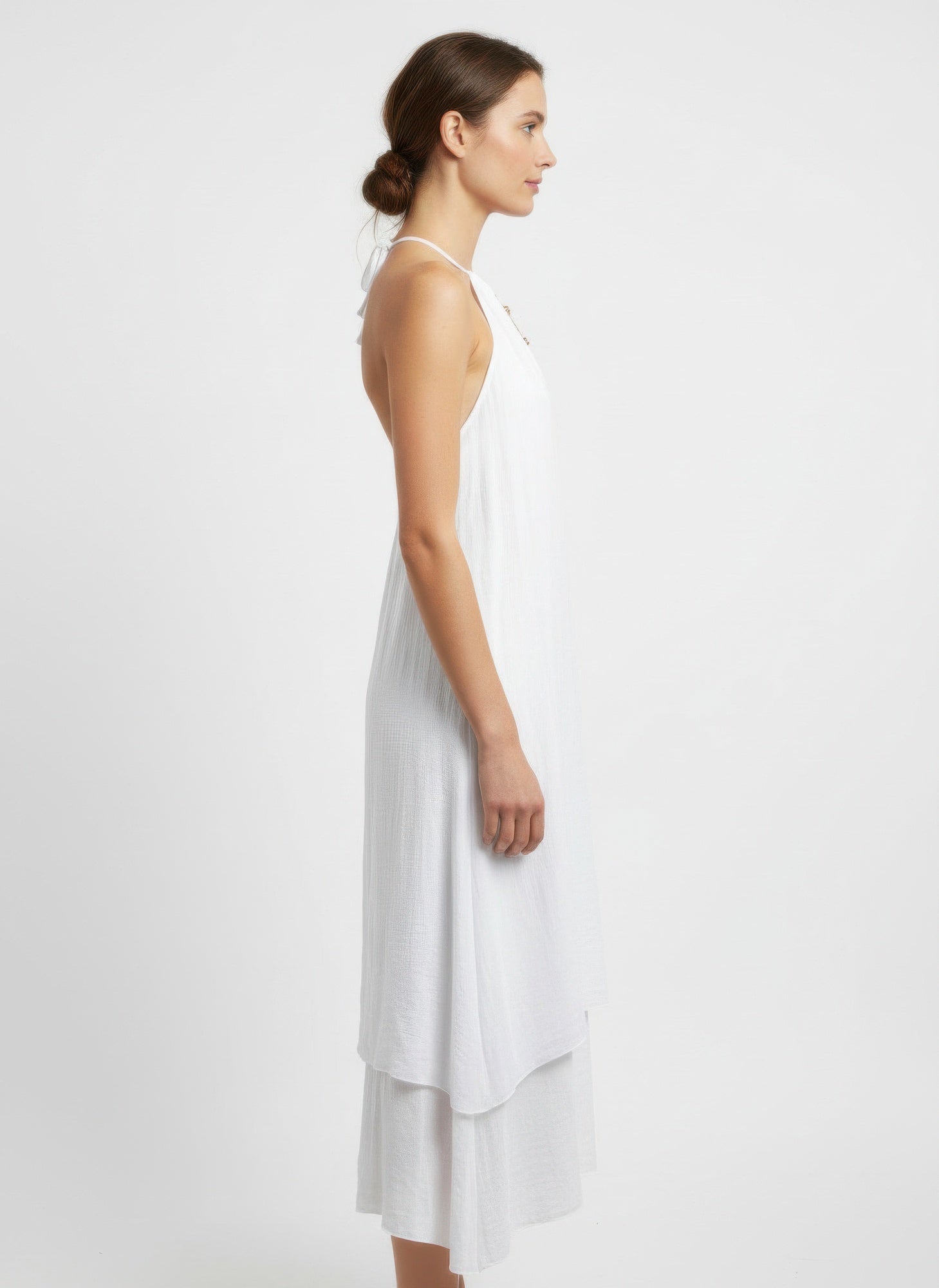 White sleeveless midi dress, side view, halter neck with tiered layered skirt