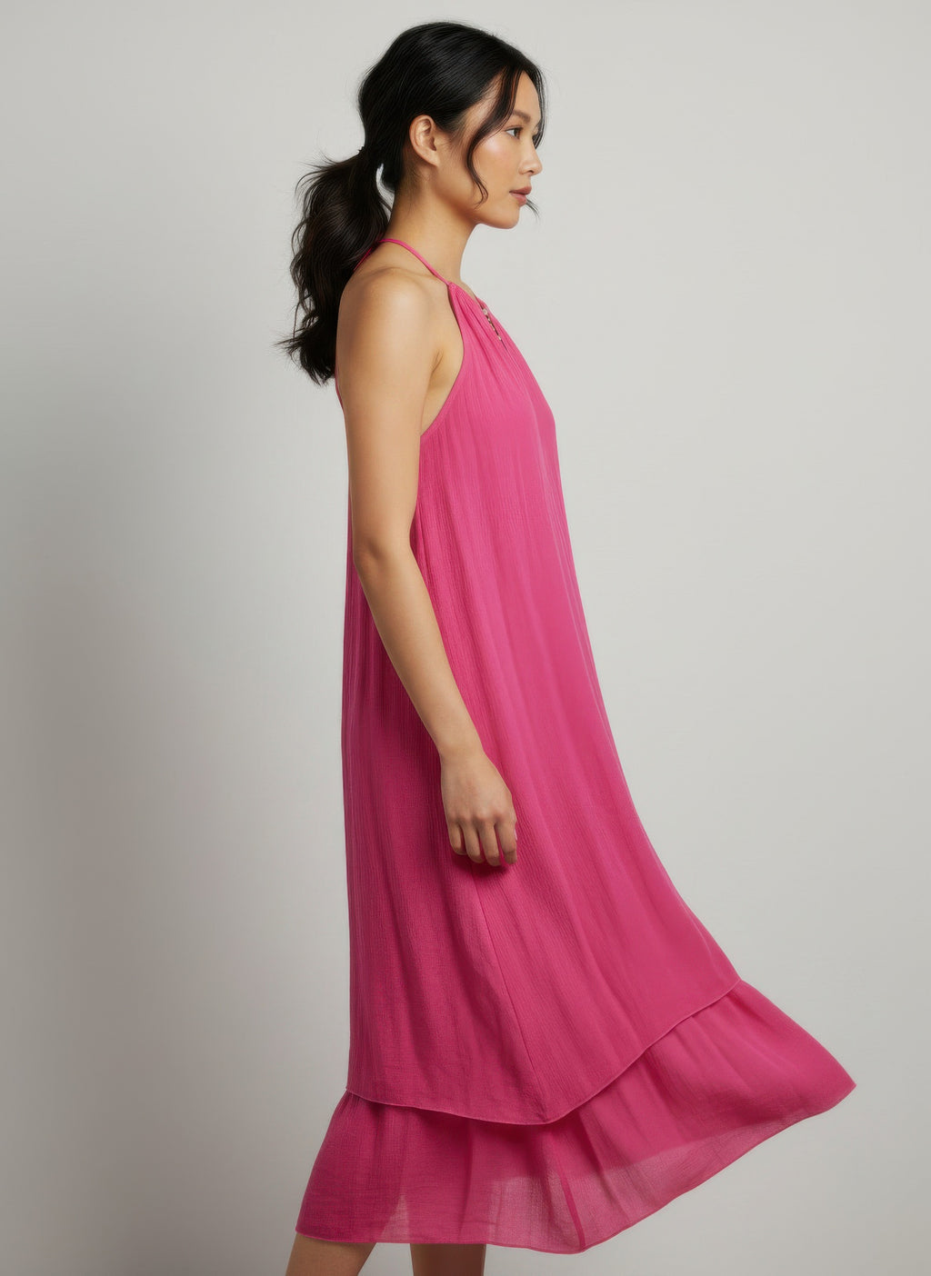 Fuchsia sleeveless midi dress, side view, halter neck with keyhole detail