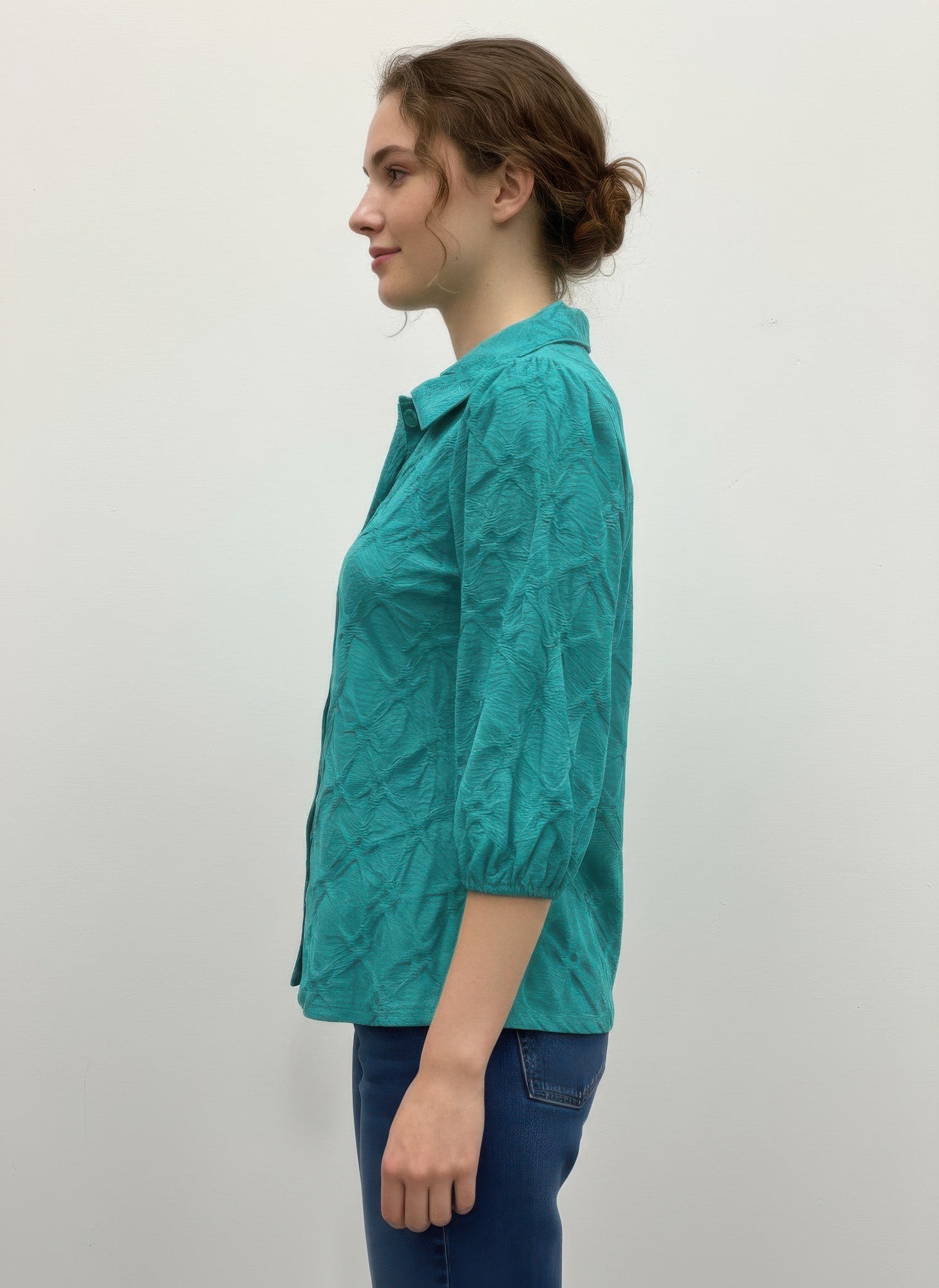 Green 3/4 sleeve blouse, side view; button front and gathered sleeves
