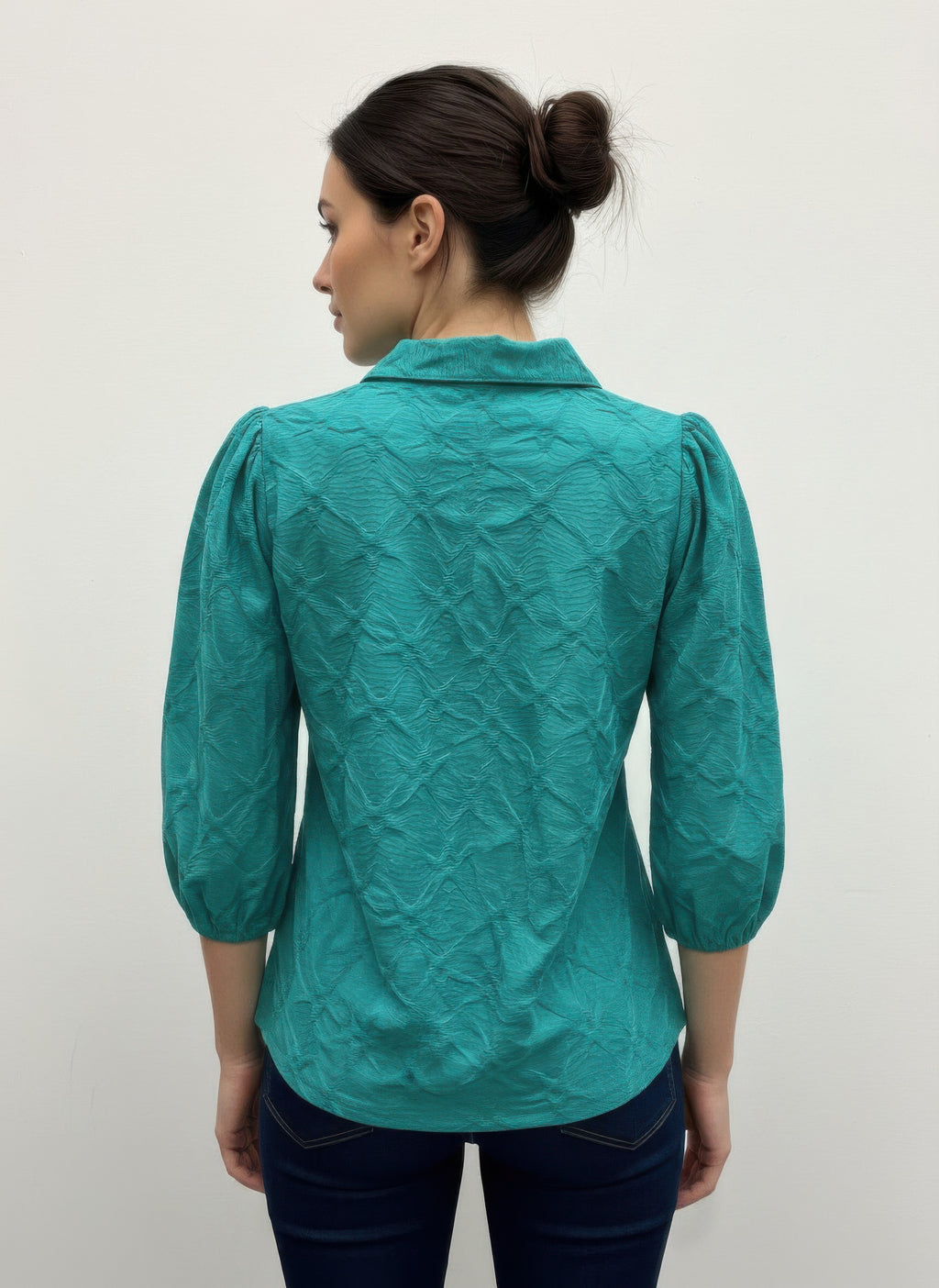 Green 3/4 sleeve blouse, back view with raised collar and textured surface