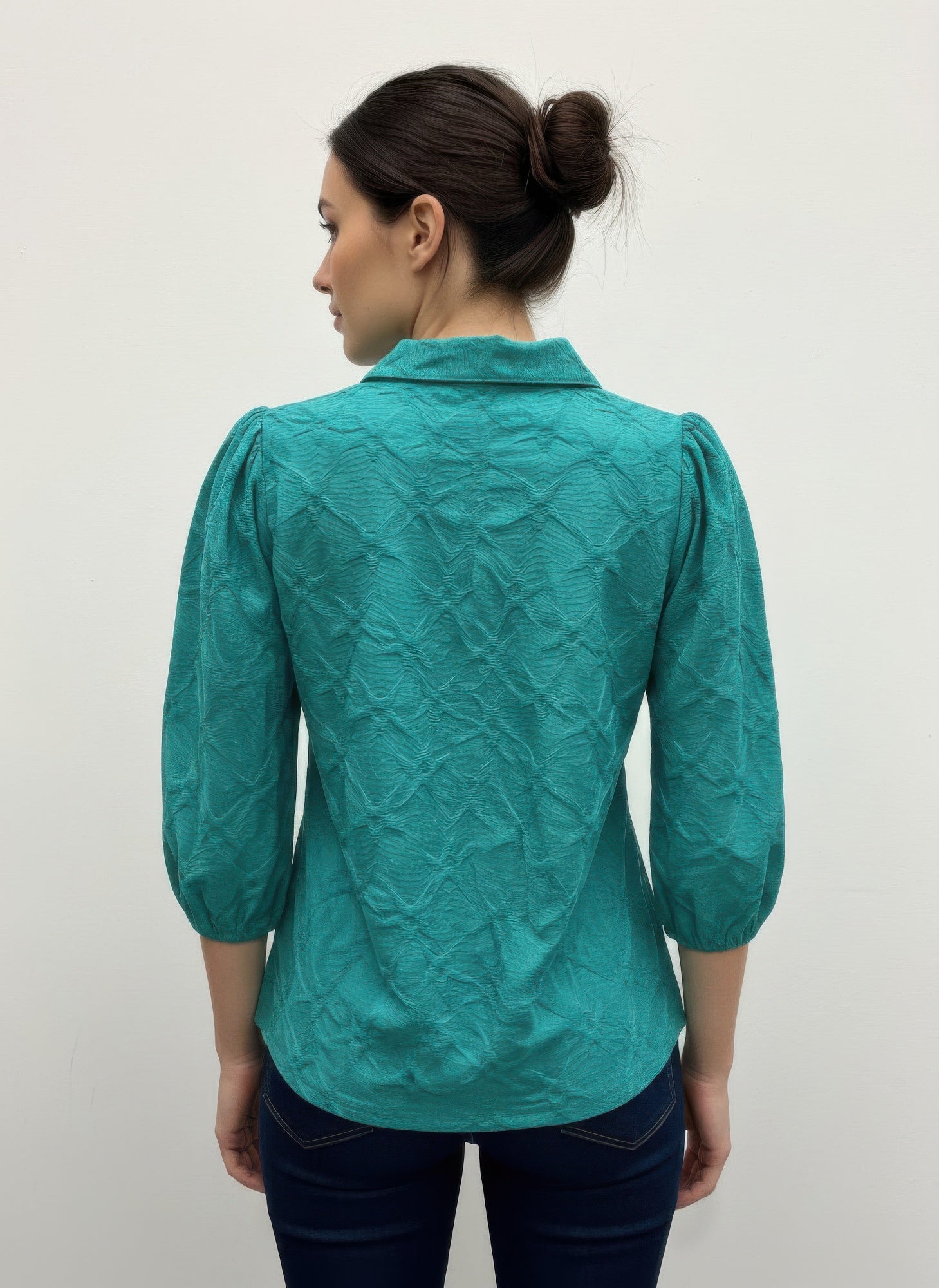 Green 3/4 sleeve blouse, back view with raised collar and textured surface