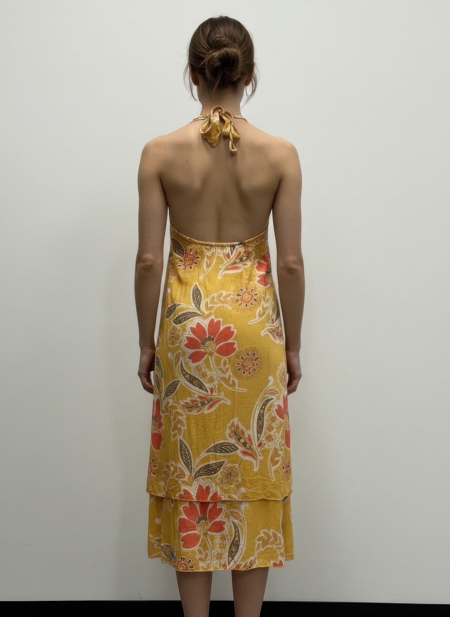 Floral sleeveless dress back view, tie-neck halter in mustard yellow floral print