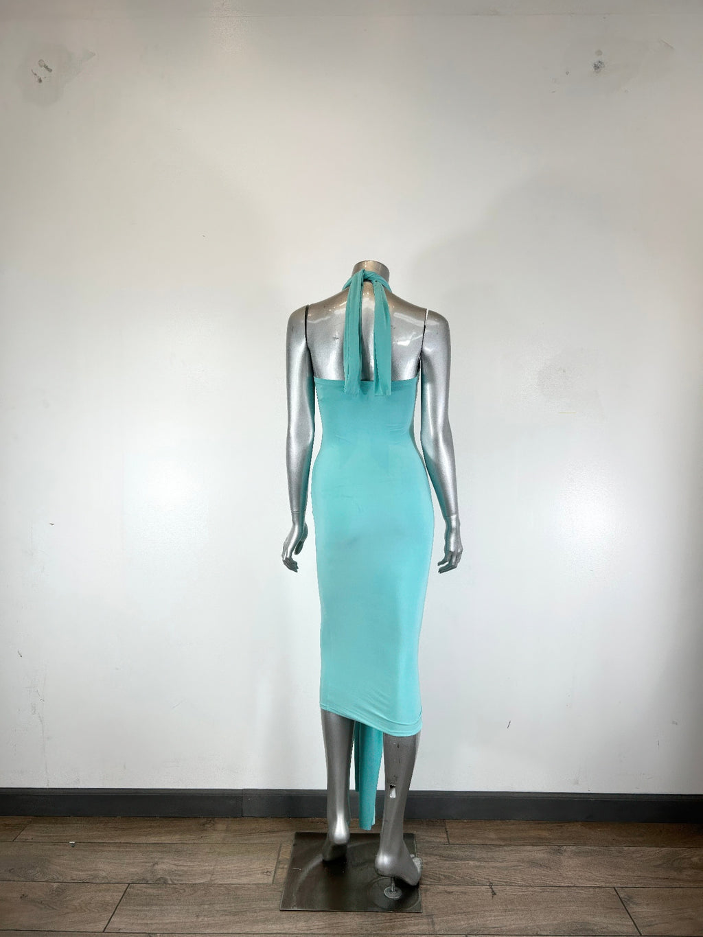 Aqua halter bodycon midi dress on mannequin, open back with thin tie straps